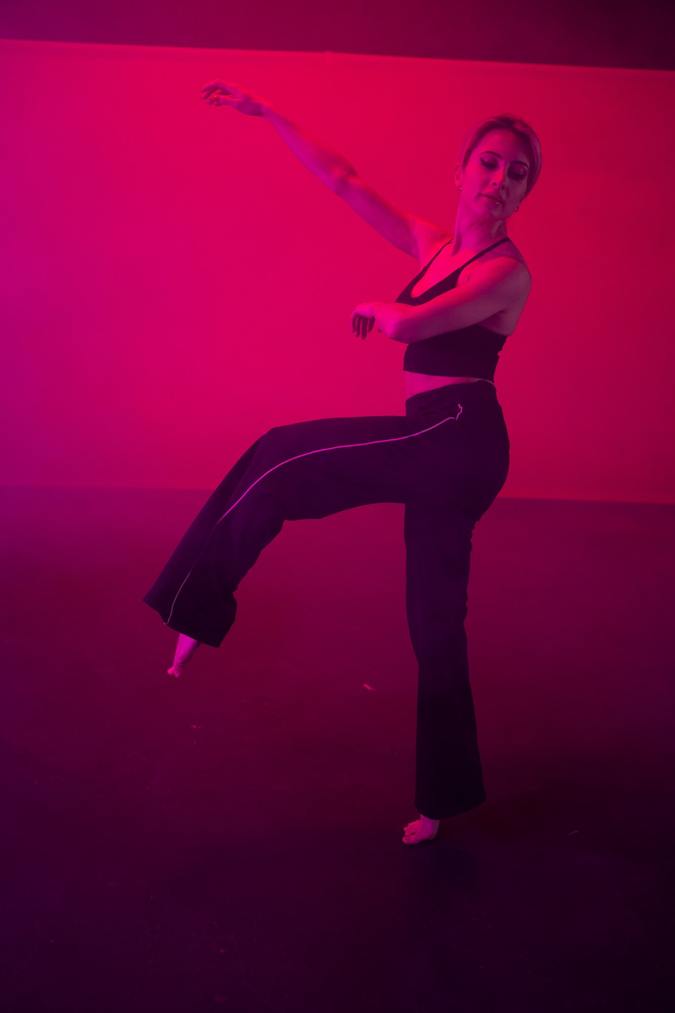 Shanelle dancing in magenta studio light
