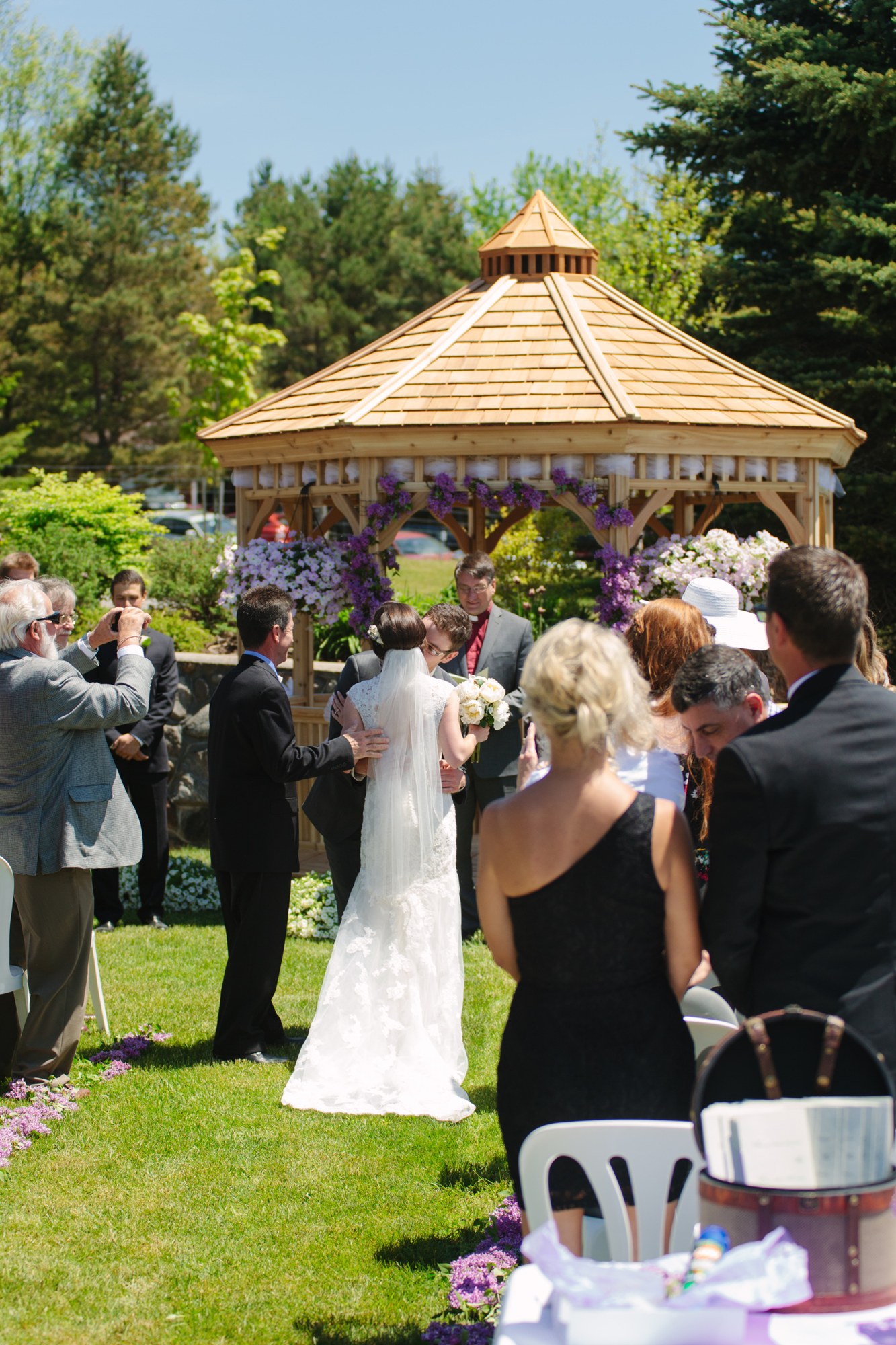 Shannon & Ehren: The ceremony beginning at the flower-lined gazebo.