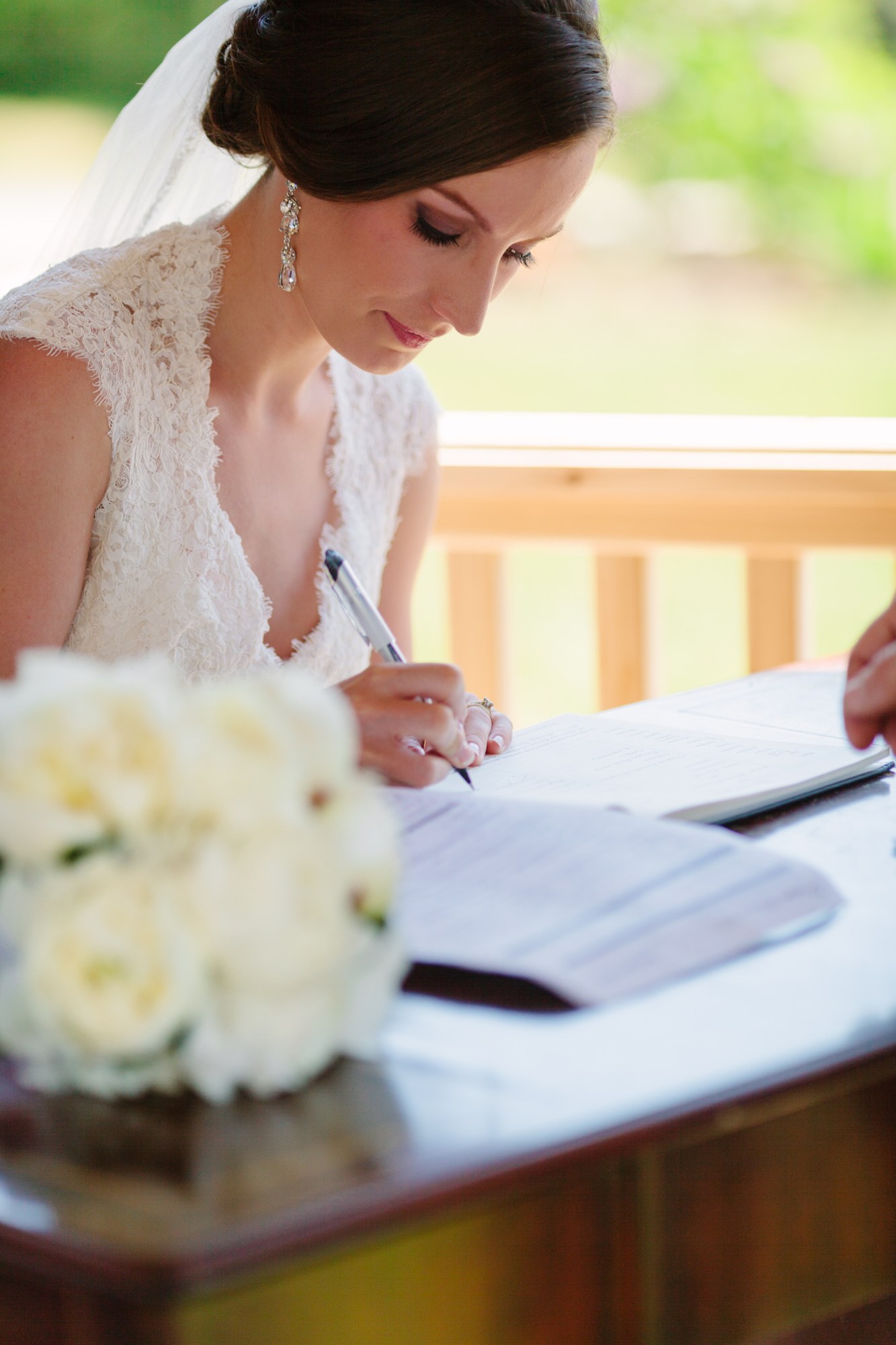 Shannon & Ehren: The bride signing the register.