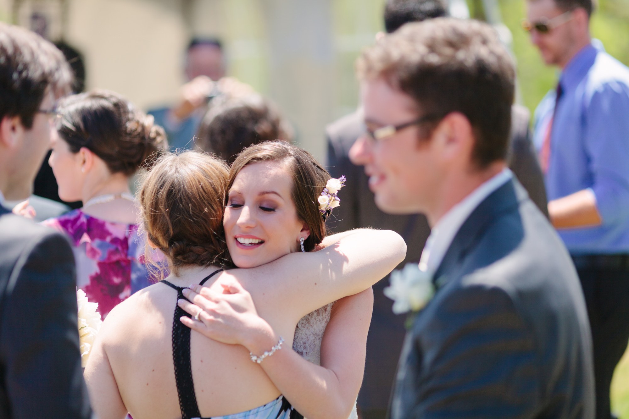 Shannon & Ehren: The bride embracing a guest.
