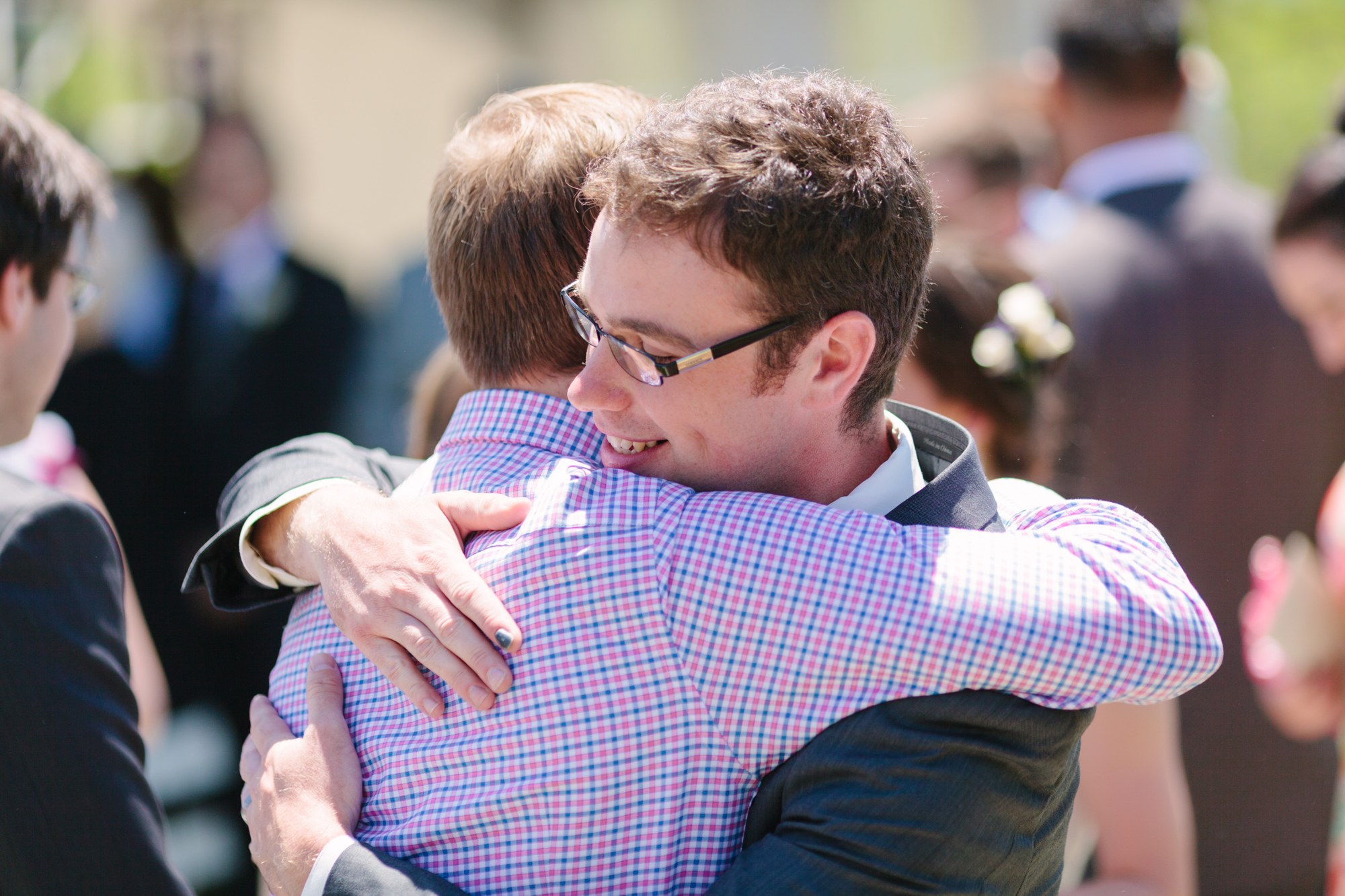 Shannon & Ehren: The groom embracing a guest.