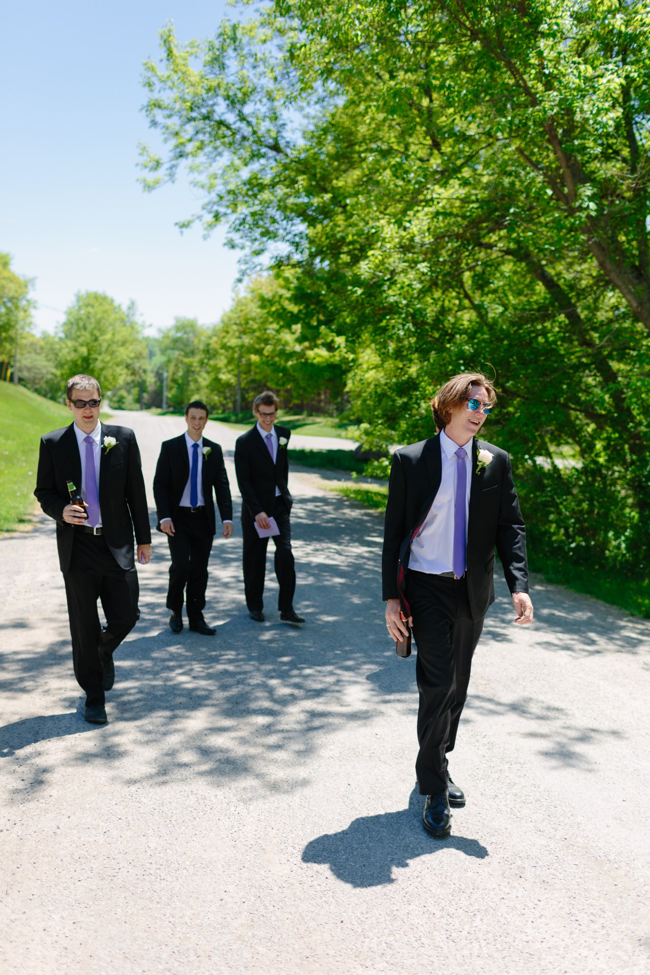 Shannon & Ehren: The groomsmen walking toward the portraits.