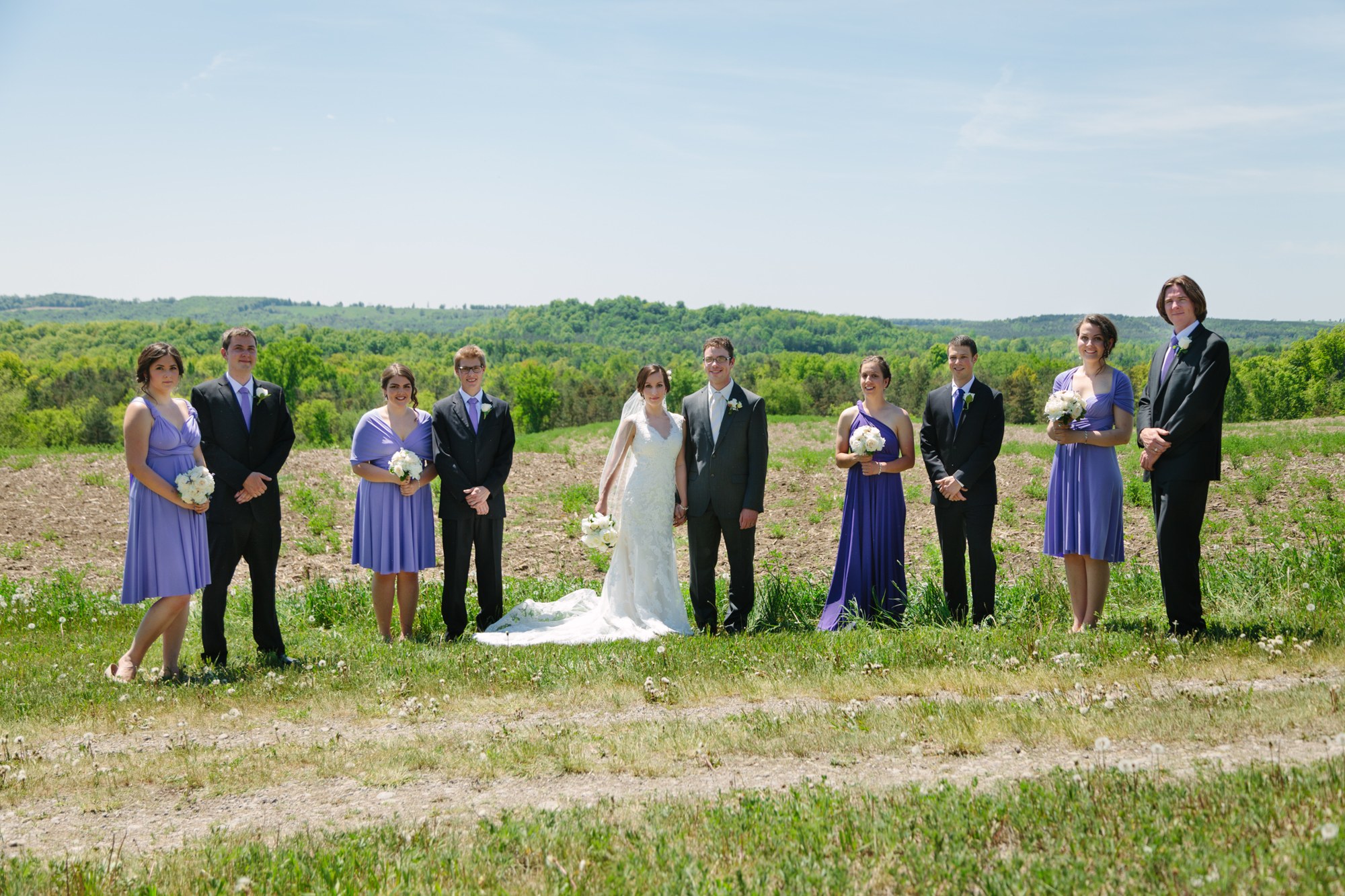 Shannon & Ehren: The full wedding party in the open field.