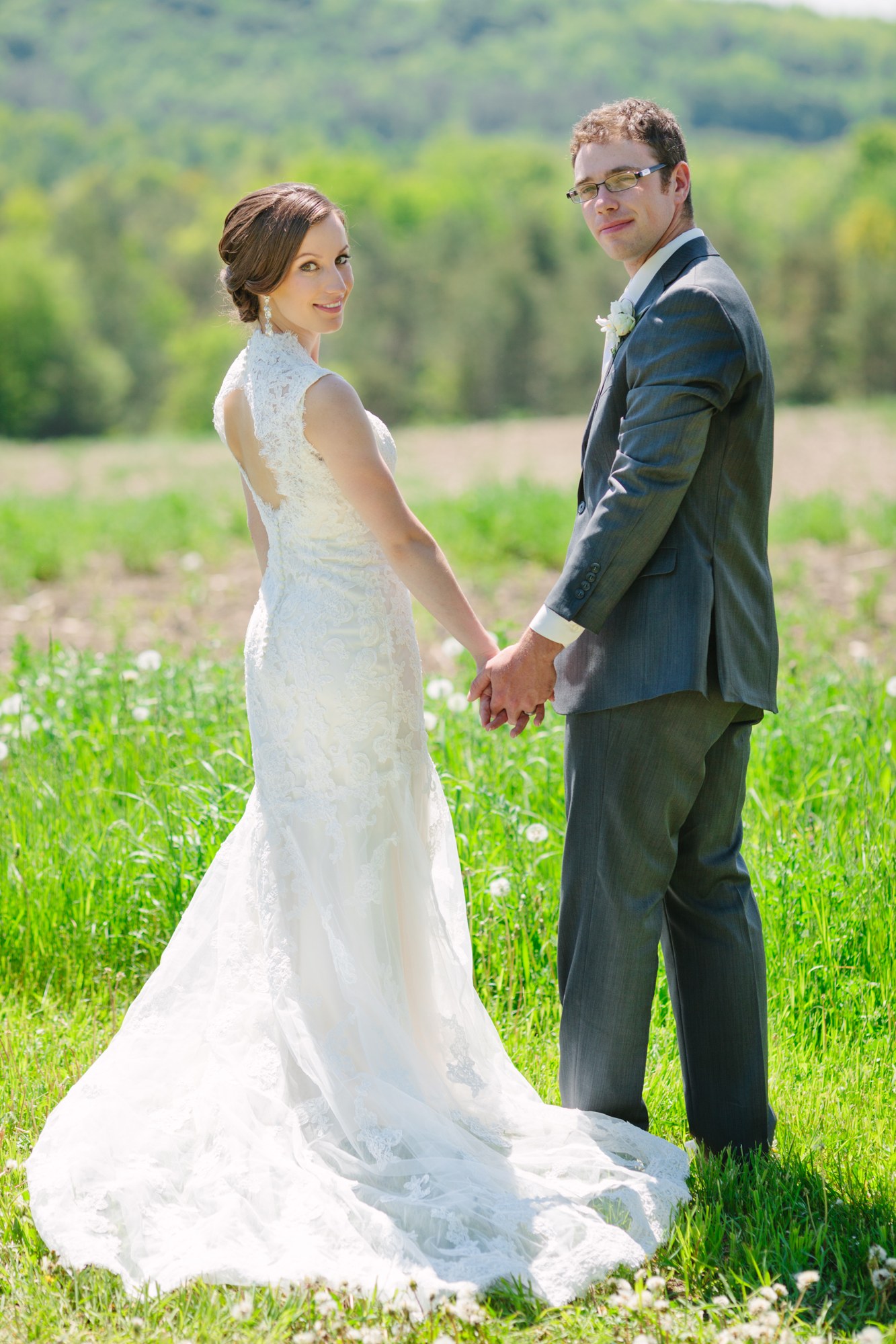 Shannon & Ehren: Full-length turned couple portrait in the grass.