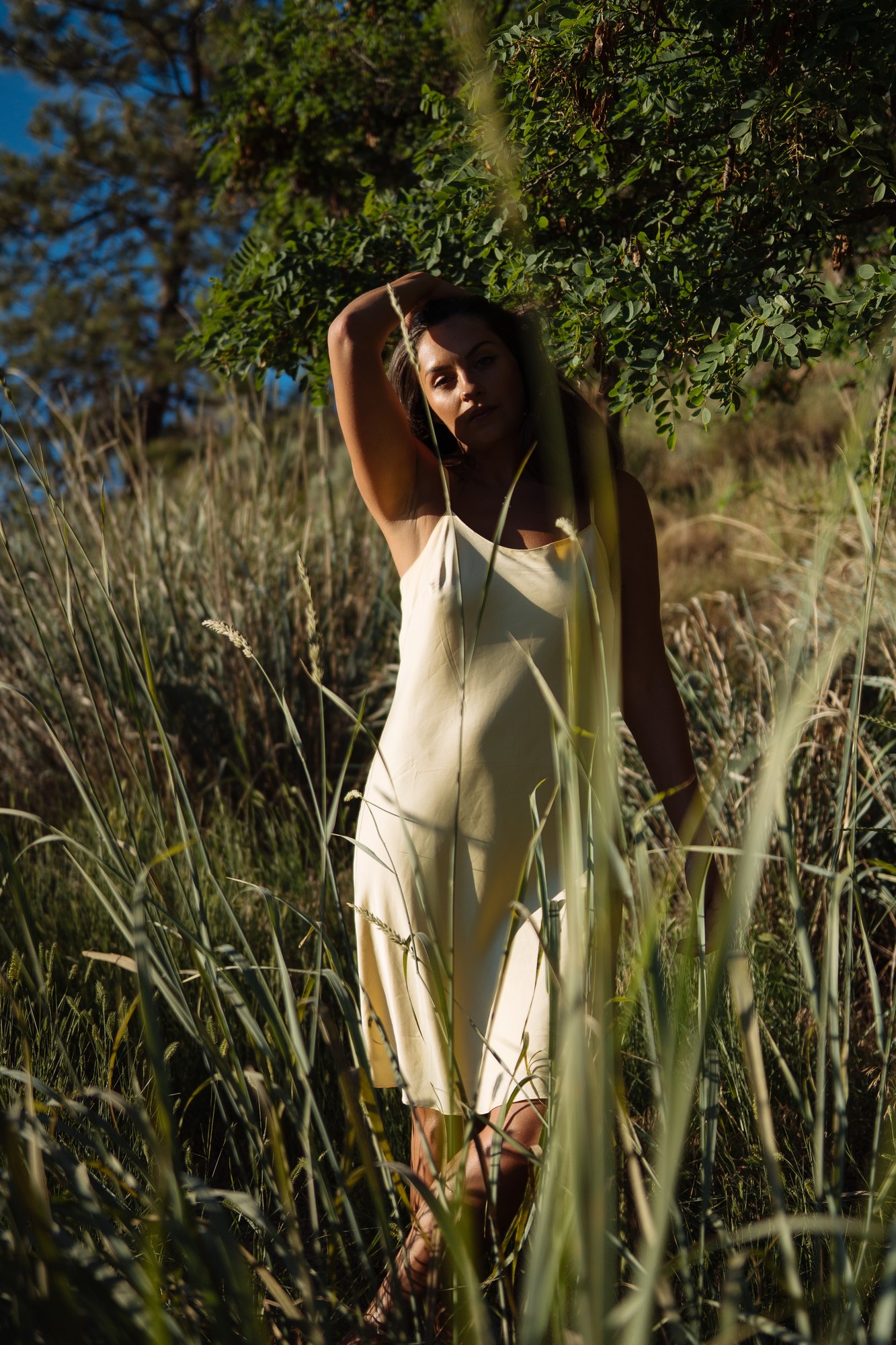 Shatille — standing among tall grass in a pale yellow dress