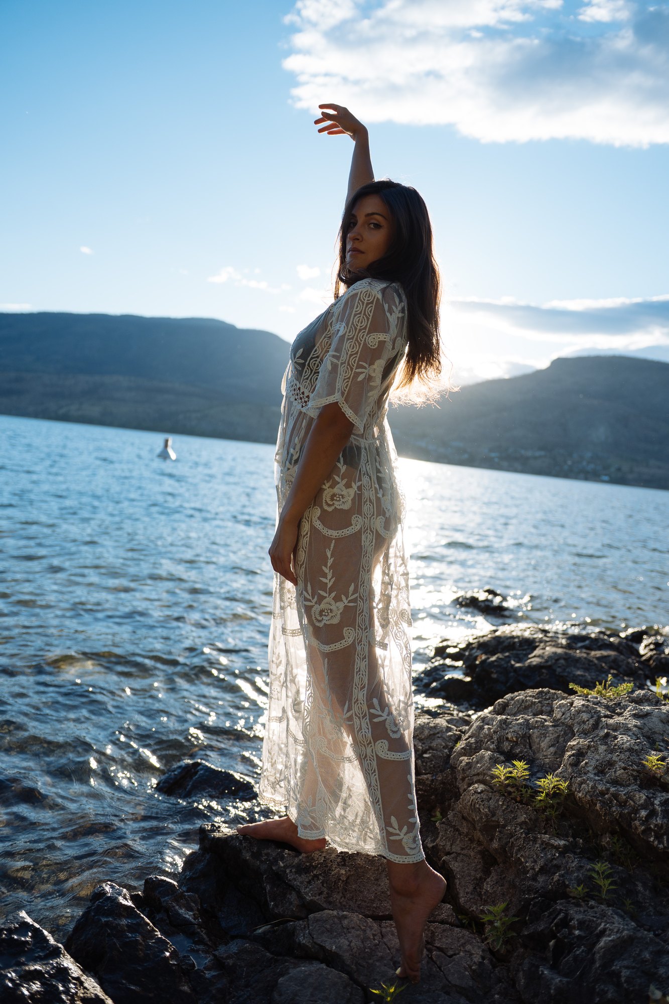 Shatille — a raised arm silhouetted against the lake