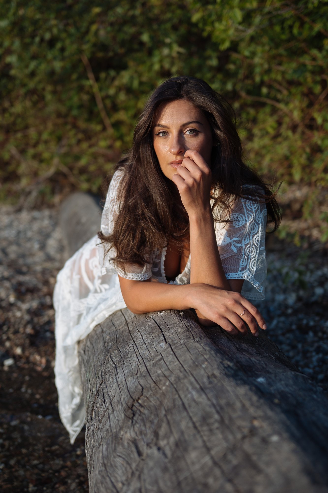 Shatille — leaning across the tree with a hand beside her face