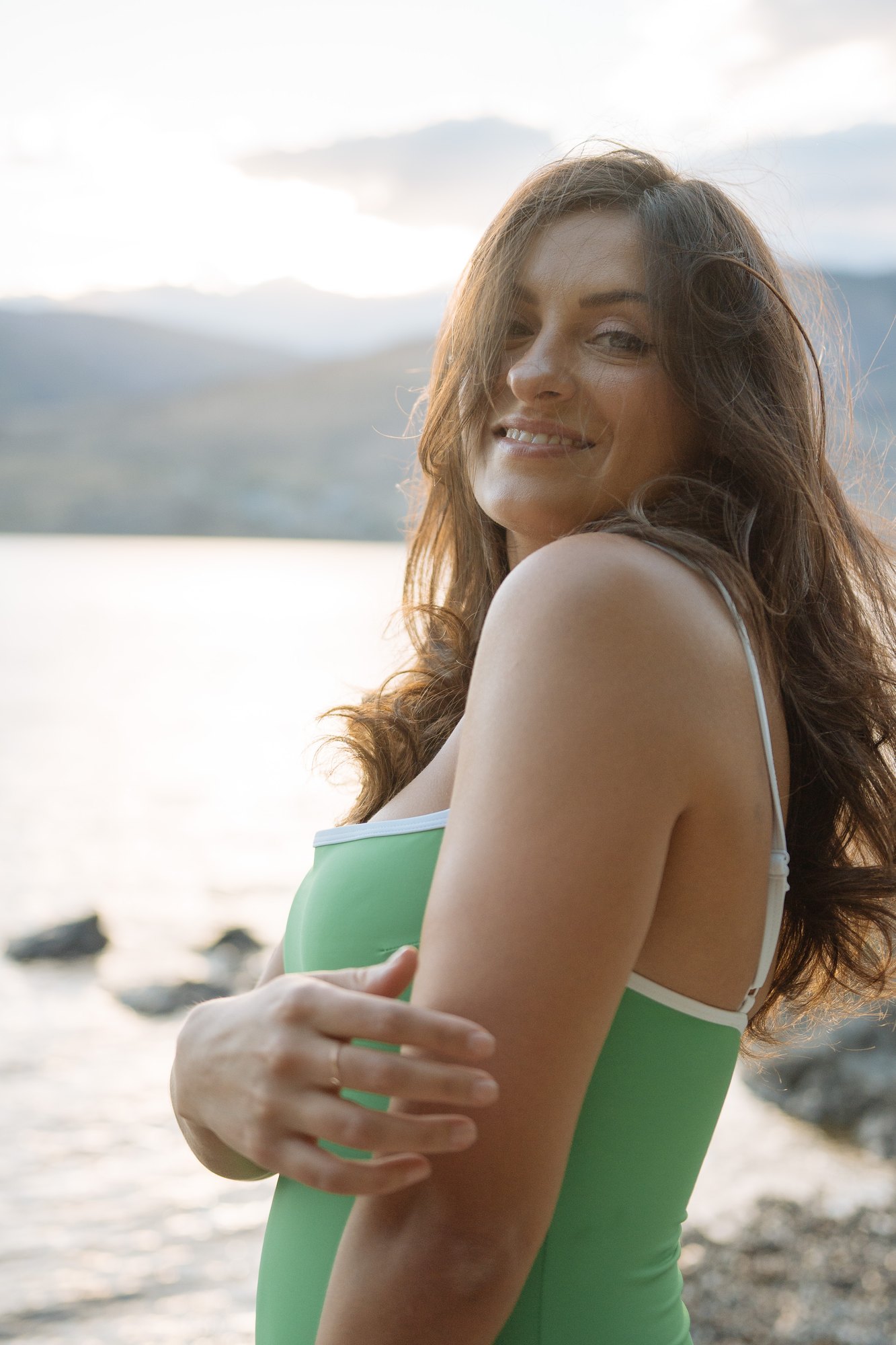 Shatille — a smile over her shoulder beside the water