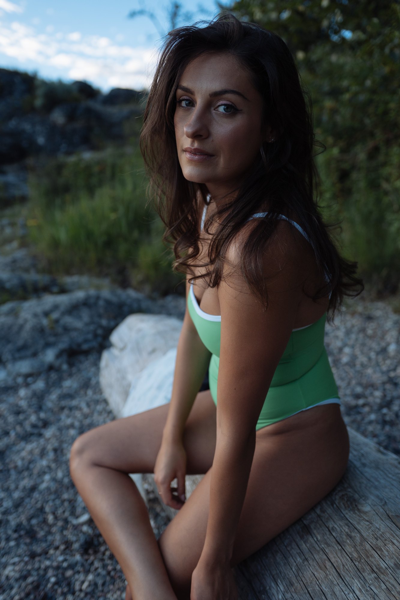 Shatille — seated portrait beside the shoreline tree
