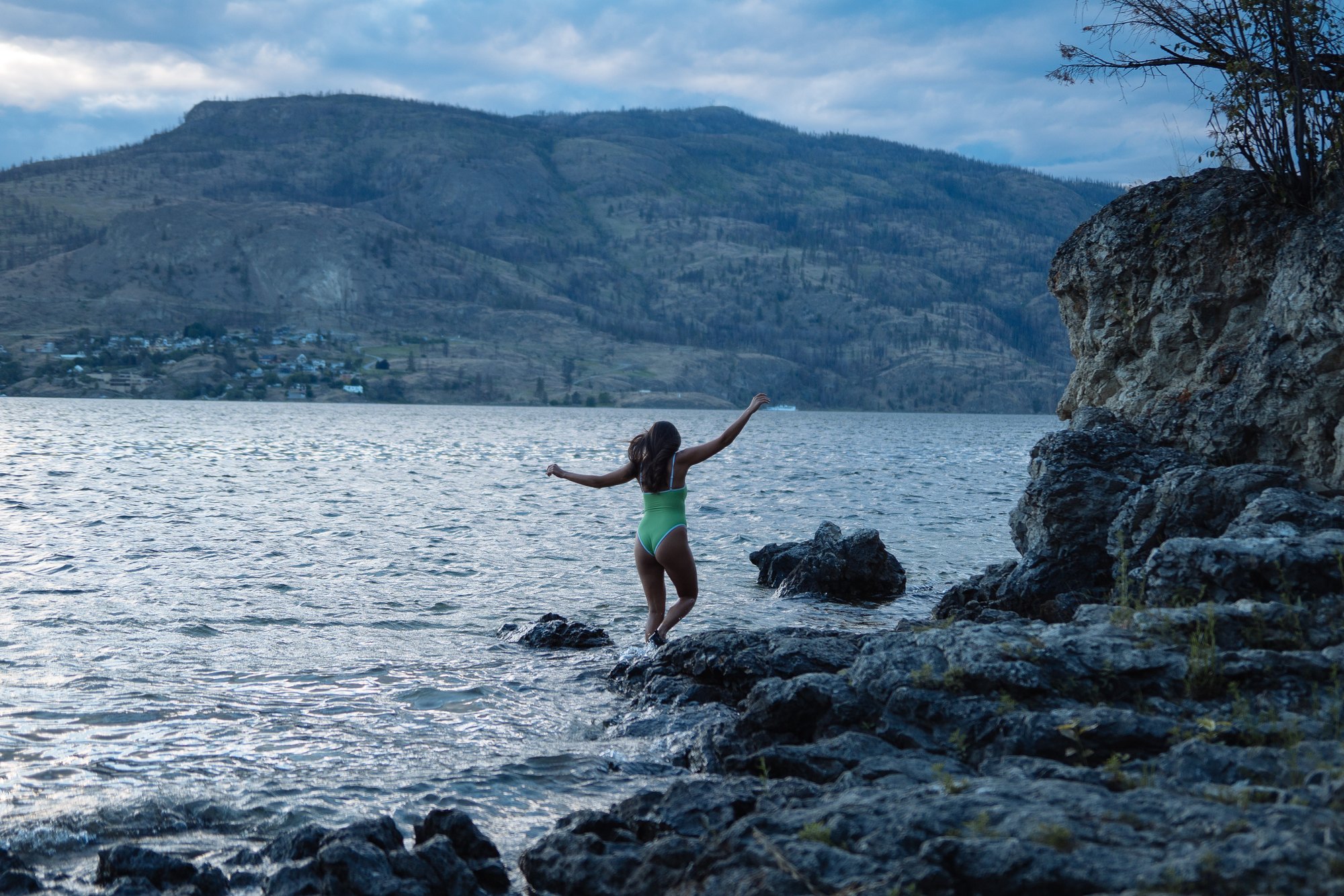 Shatille — a wide view of her standing among rocks in the lake