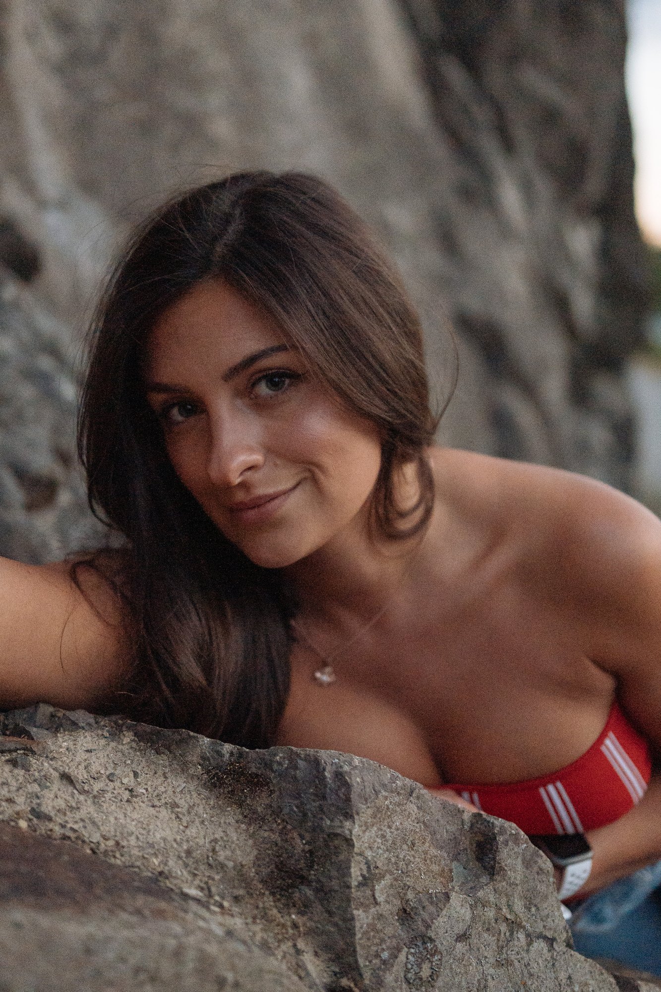 Shatille — leaning across a rock with a quiet smile