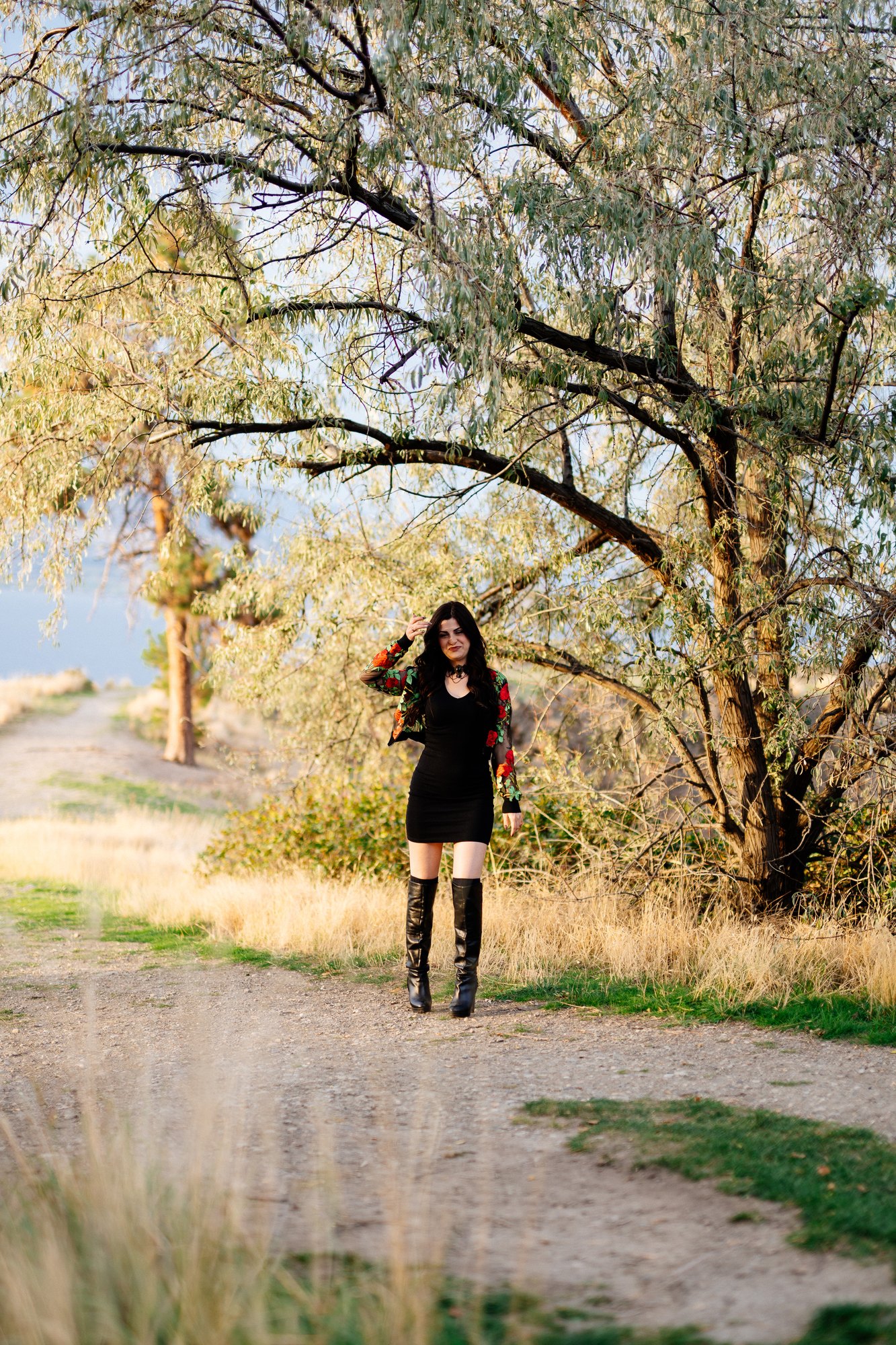 Sophia — standing beneath autumn branches above the lake