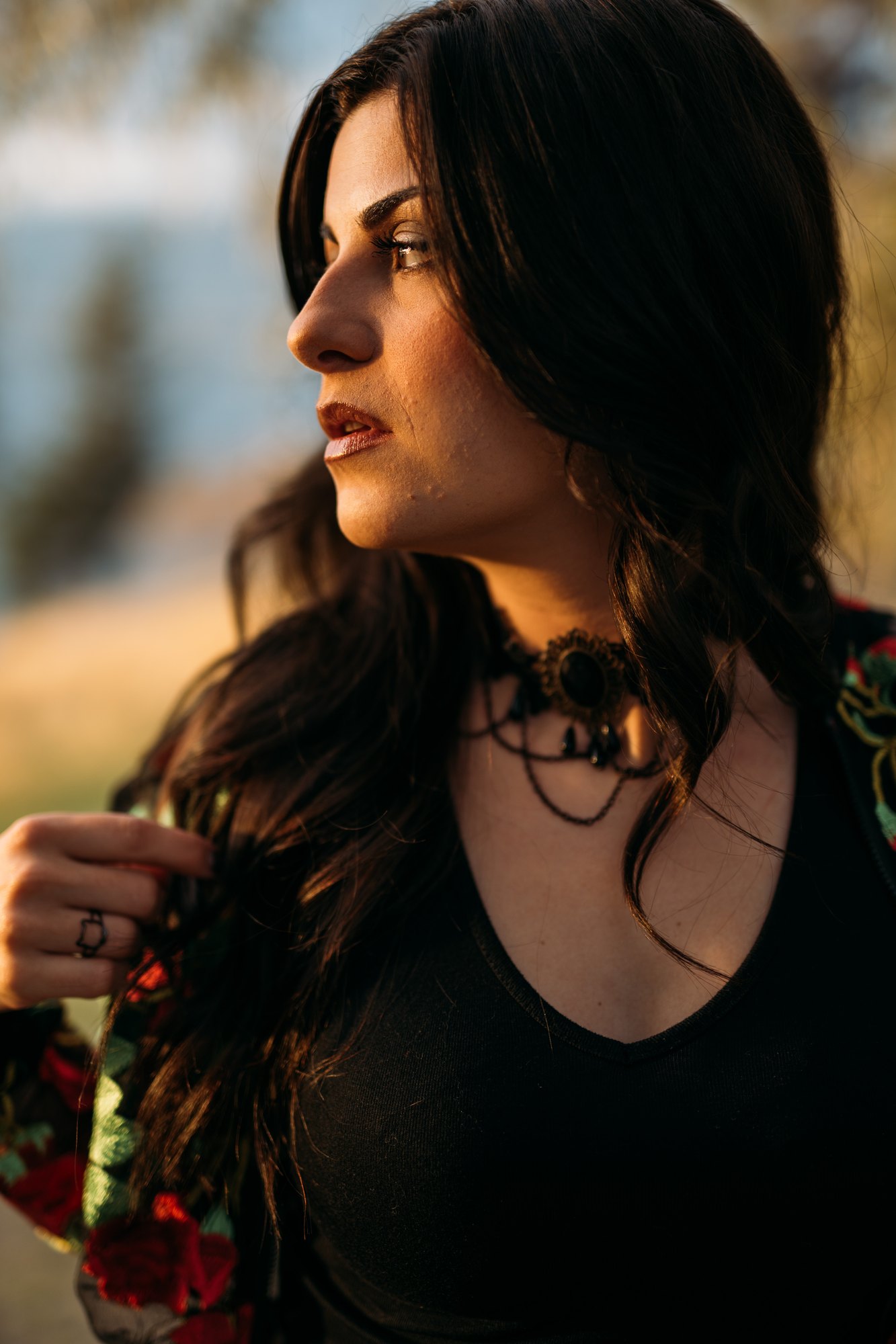 Sophia — side portrait in a black dress and floral jacket
