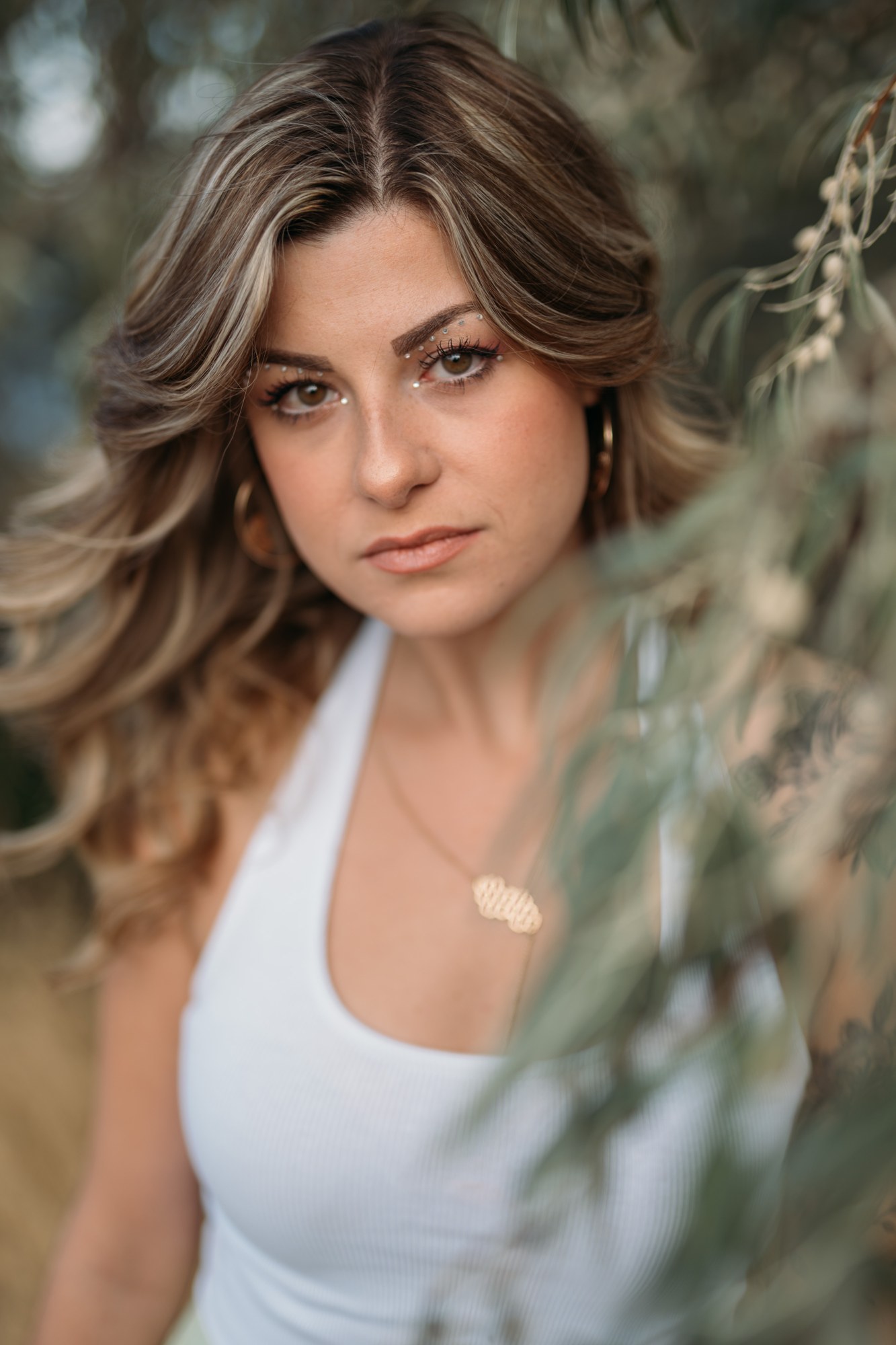 Sophia at Bertram Creek Park: Face framed by willow foliage.