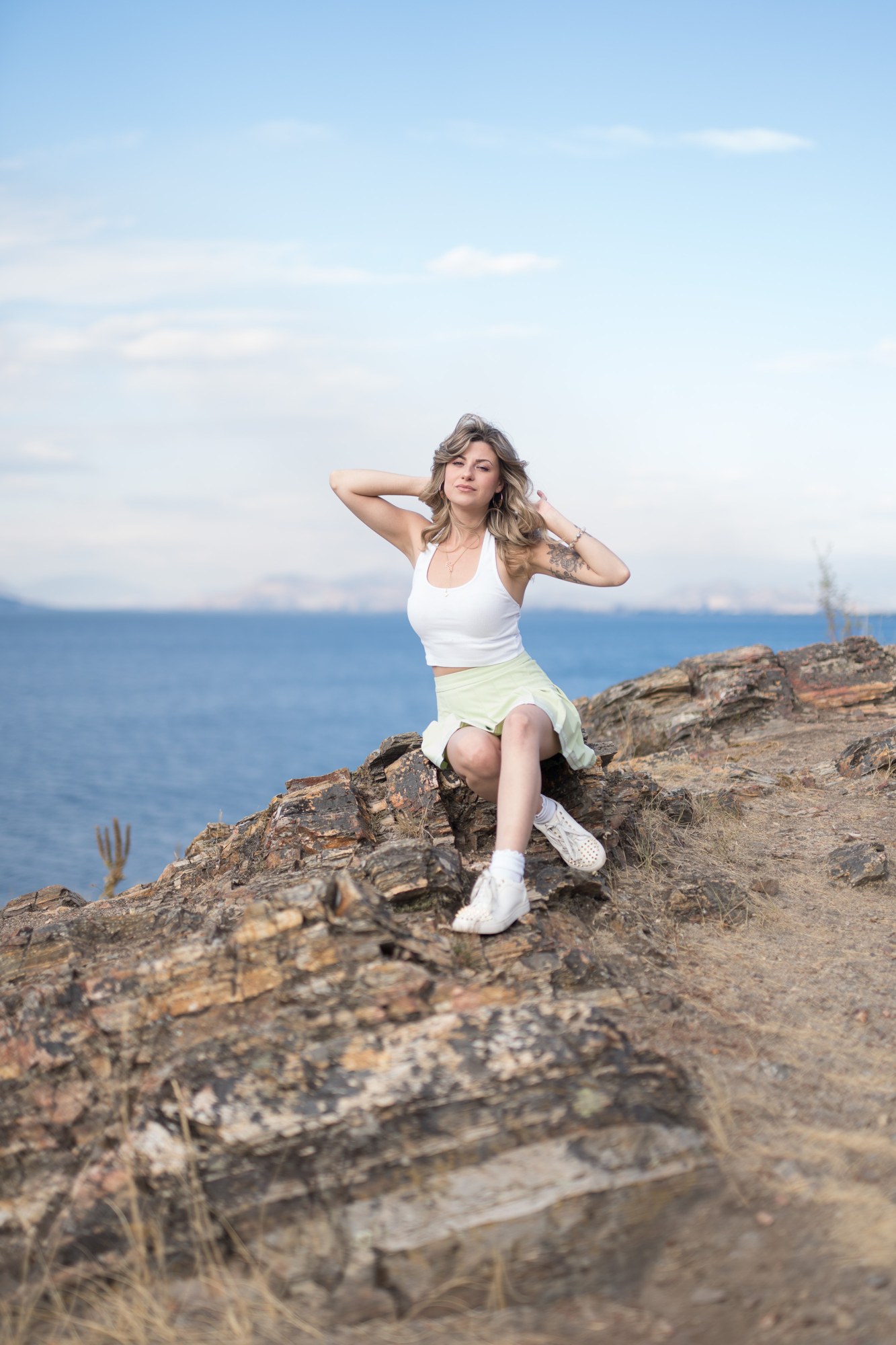 Sophia at Bertram Creek Park: Seated landscape portrait above the lake.