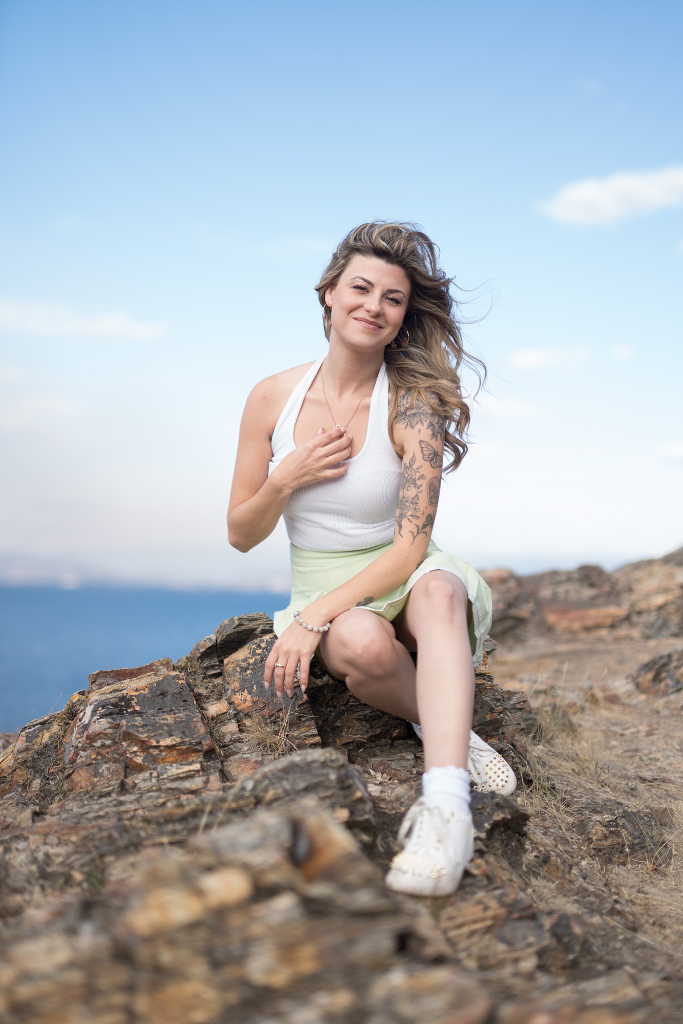 Sophia at Bertram Creek Park: Hand-to-chest smile on the rock.