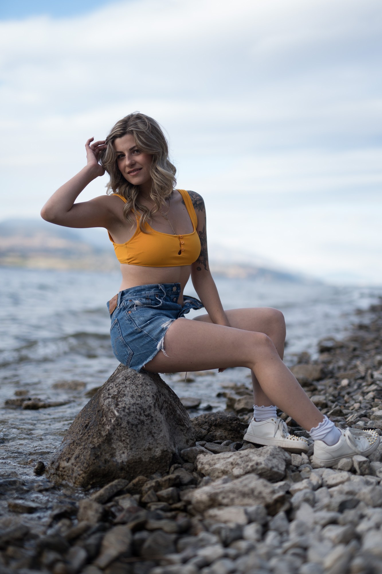 Sophia at Bertram Creek Park: Smiling seated portrait on the rock.