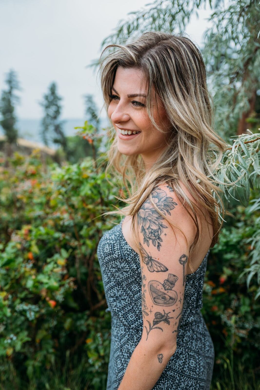 Sophia by the Lake portraits story frame 2: A multi-outfit Okanagan location session with water, trees, shoreline, denim and red swimwear woven into a summer portrait story.