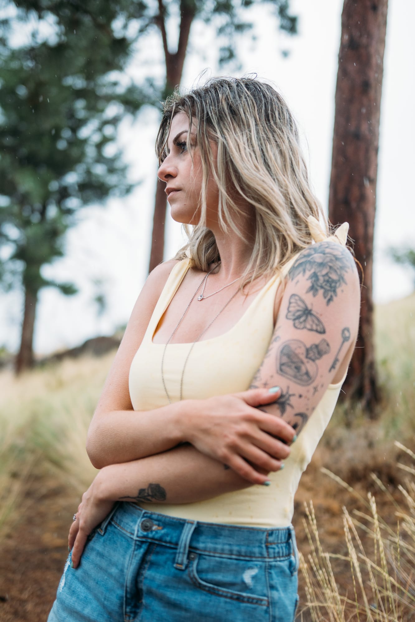 Sophia by the Lake portraits story frame 18: A multi-outfit Okanagan location session with water, trees, shoreline, denim and red swimwear woven into a summer portrait story.