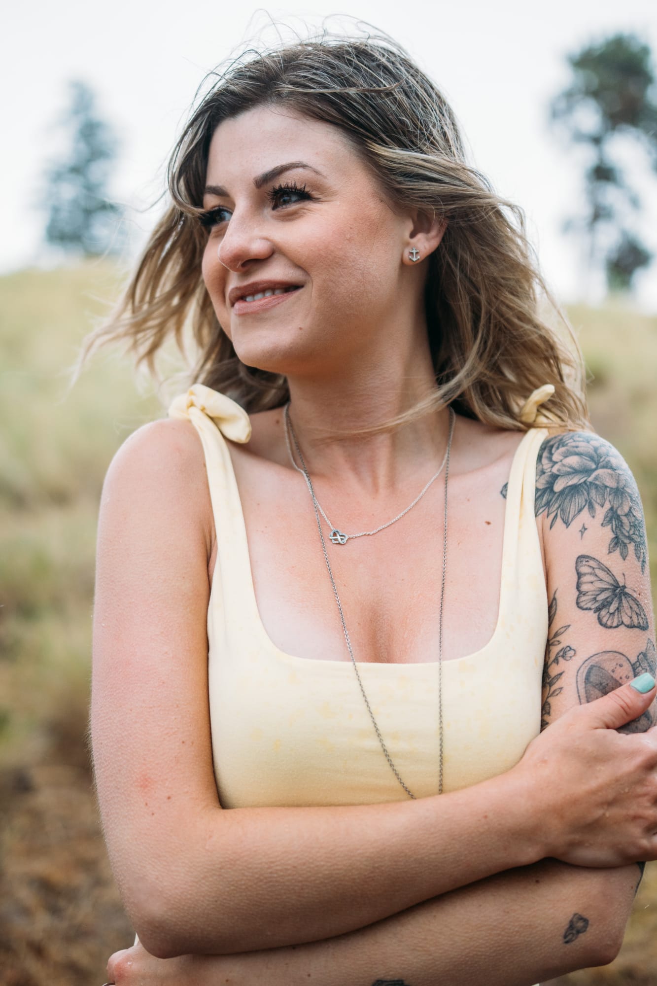 Sophia by the Lake portraits story frame 19: A multi-outfit Okanagan location session with water, trees, shoreline, denim and red swimwear woven into a summer portrait story.