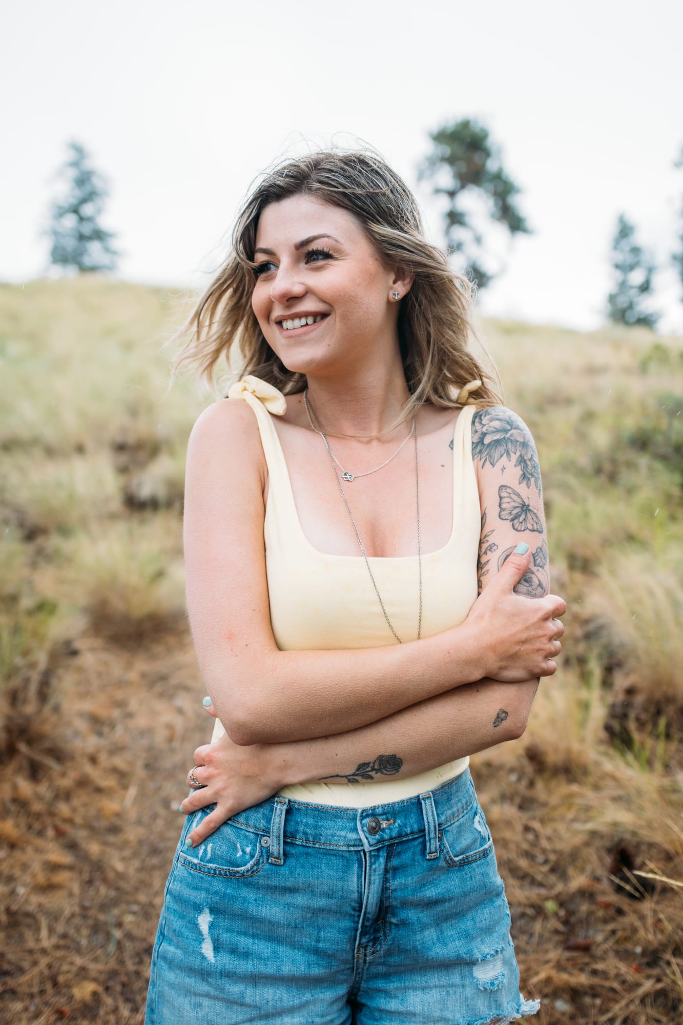 Sophia by the Lake portraits story frame 20: A multi-outfit Okanagan location session with water, trees, shoreline, denim and red swimwear woven into a summer portrait story.