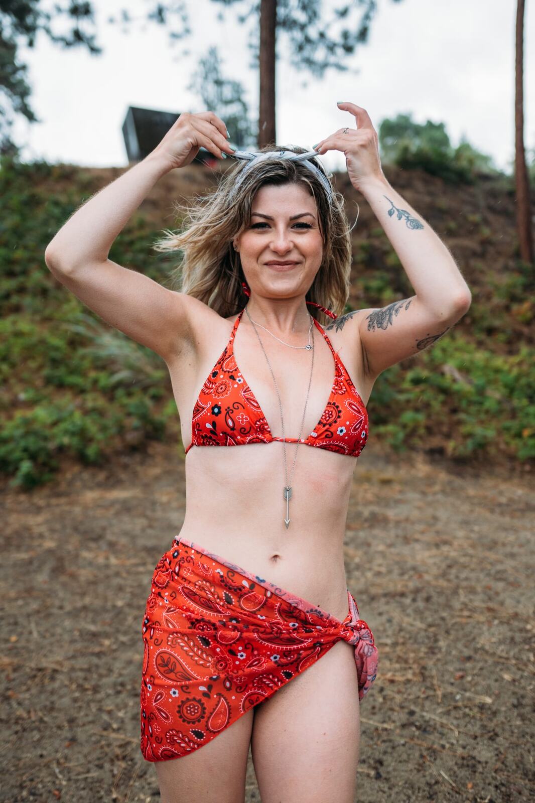 Sophia by the Lake portraits story frame 21: A multi-outfit Okanagan location session with water, trees, shoreline, denim and red swimwear woven into a summer portrait story.