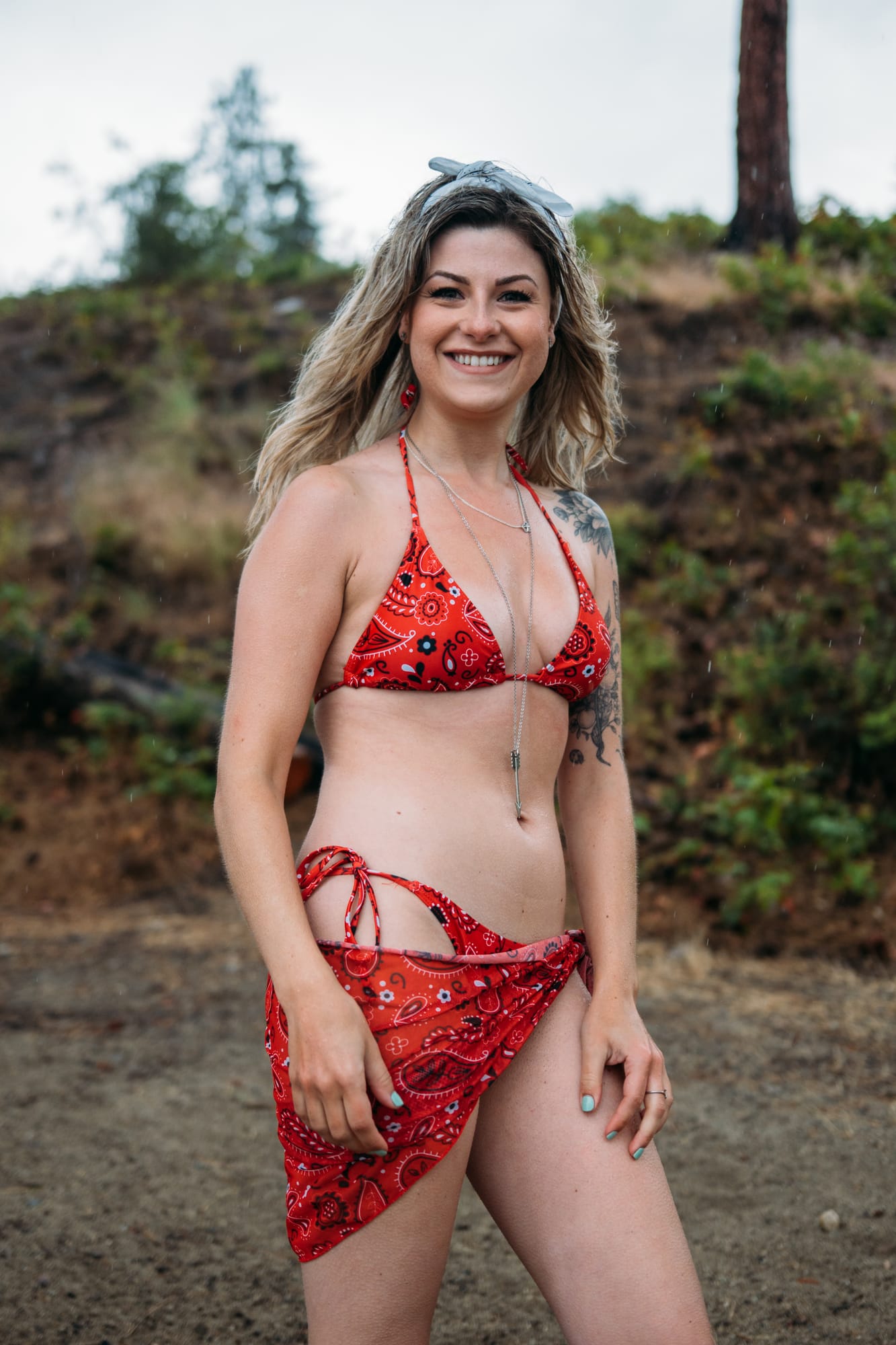 Sophia by the Lake portraits story frame 30: A multi-outfit Okanagan location session with water, trees, shoreline, denim and red swimwear woven into a summer portrait story.