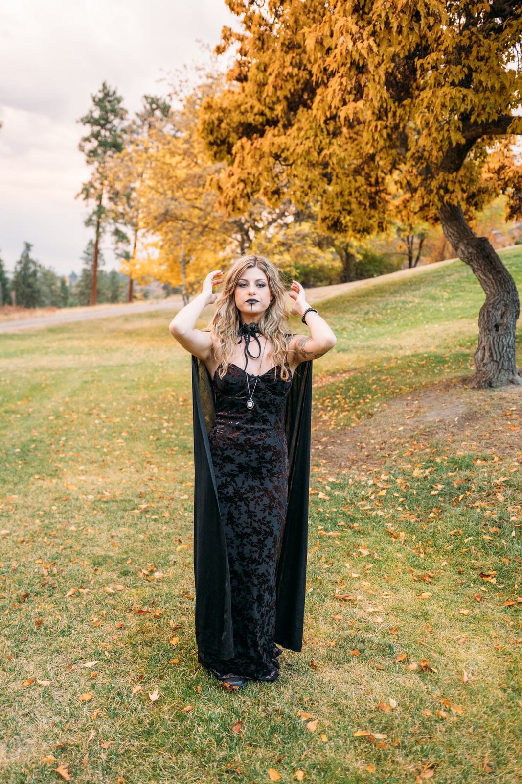 Sophia Halloween portraits story frame 1: A darker seasonal portrait story with candles, rain, rocks, and a little ritual atmosphere.