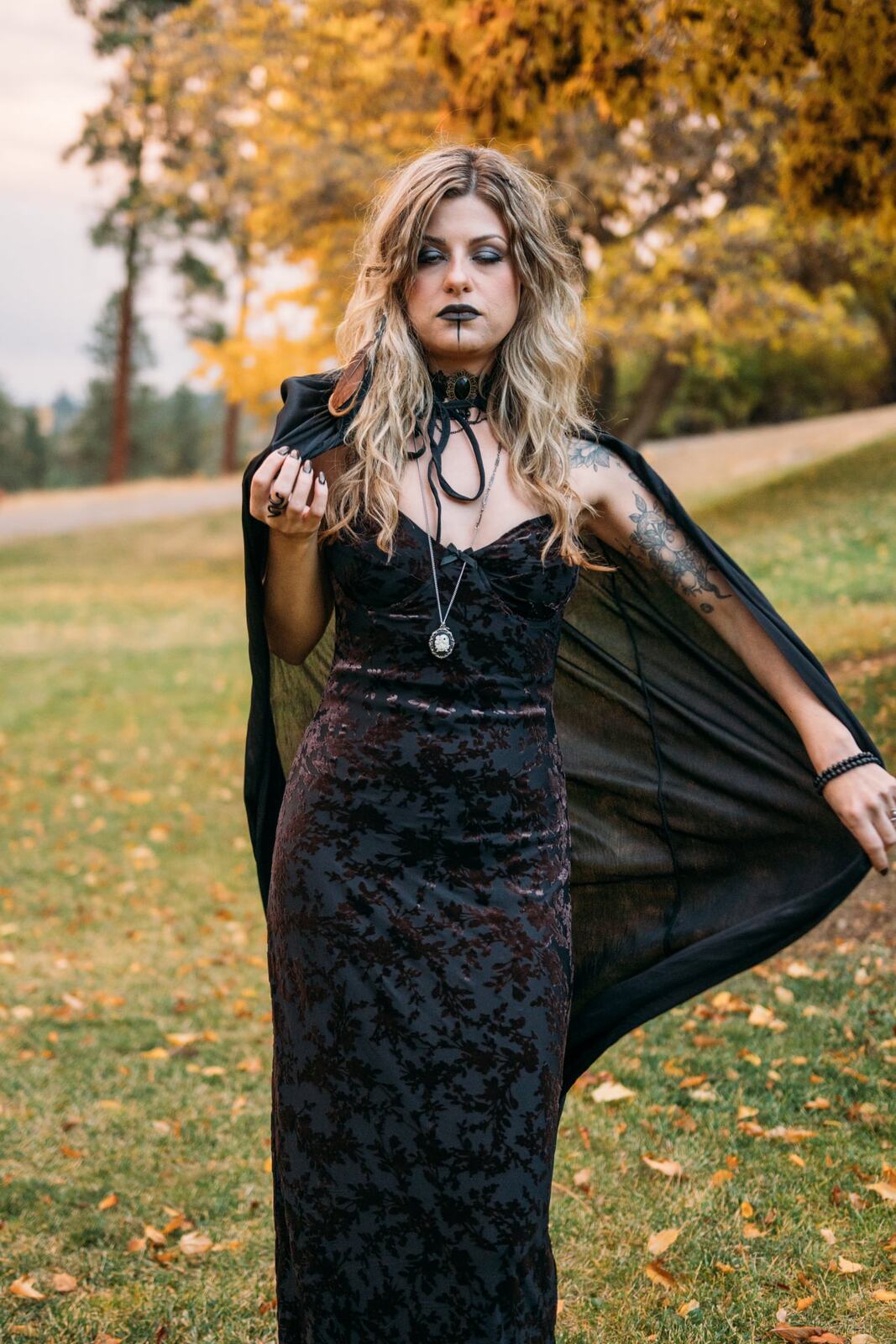Sophia Halloween portraits story frame 3: A darker seasonal portrait story with candles, rain, rocks, and a little ritual atmosphere.