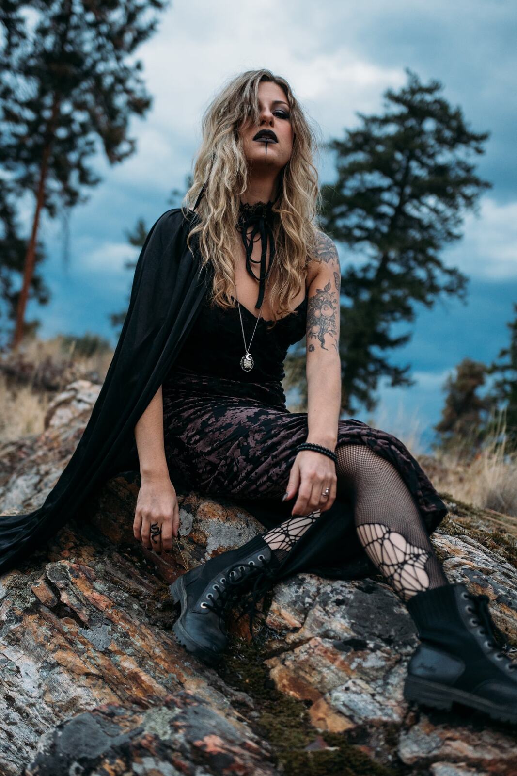 Sophia Halloween portraits story frame 15: A darker seasonal portrait story with candles, rain, rocks, and a little ritual atmosphere.