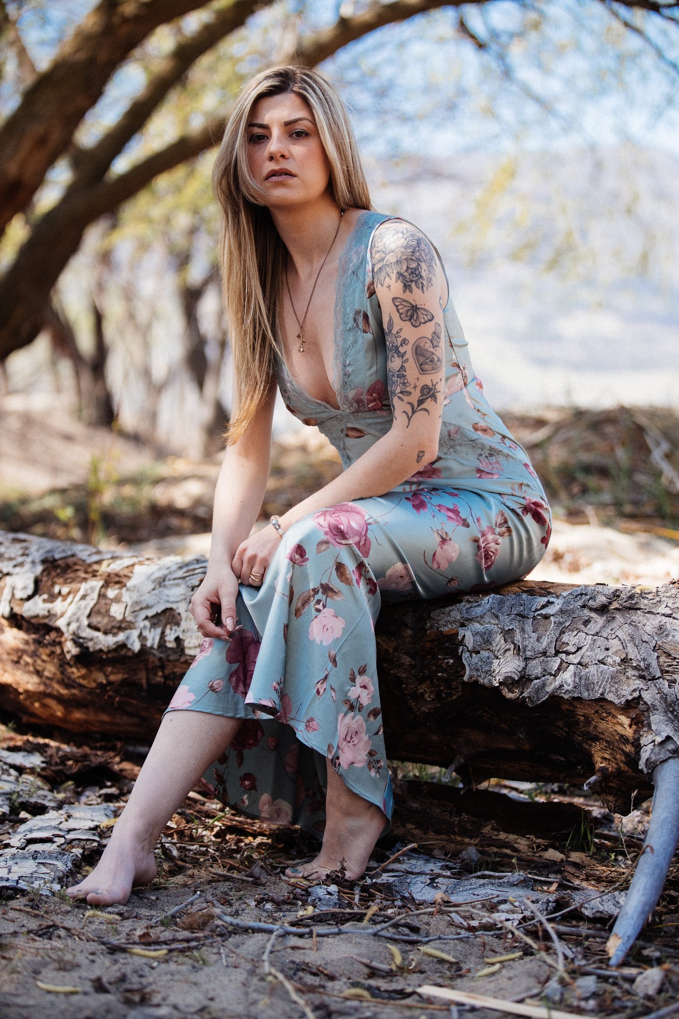 Sophia — leaning forward on the fallen tree