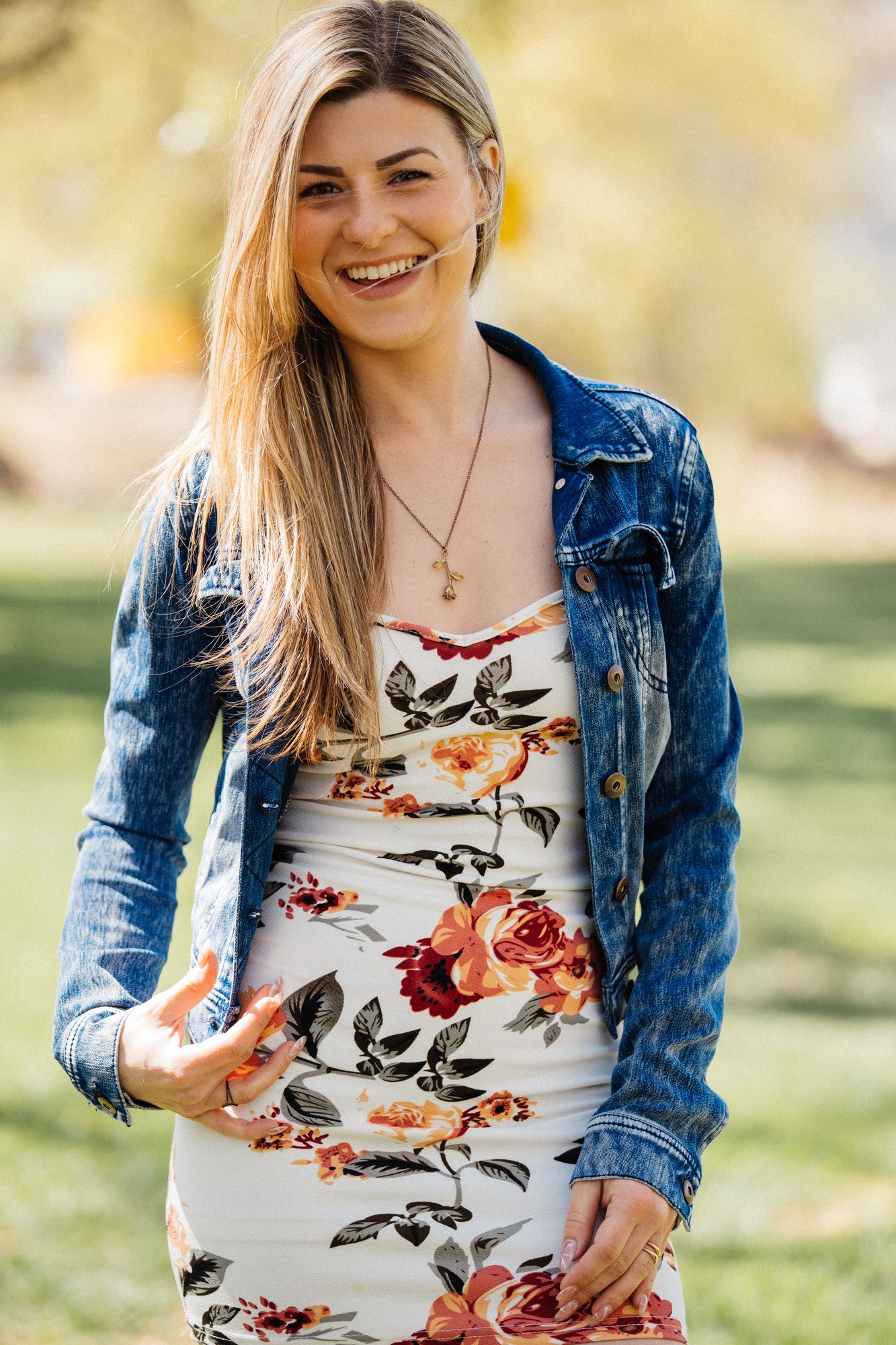 Sophia — smiling in a denim jacket and floral dress