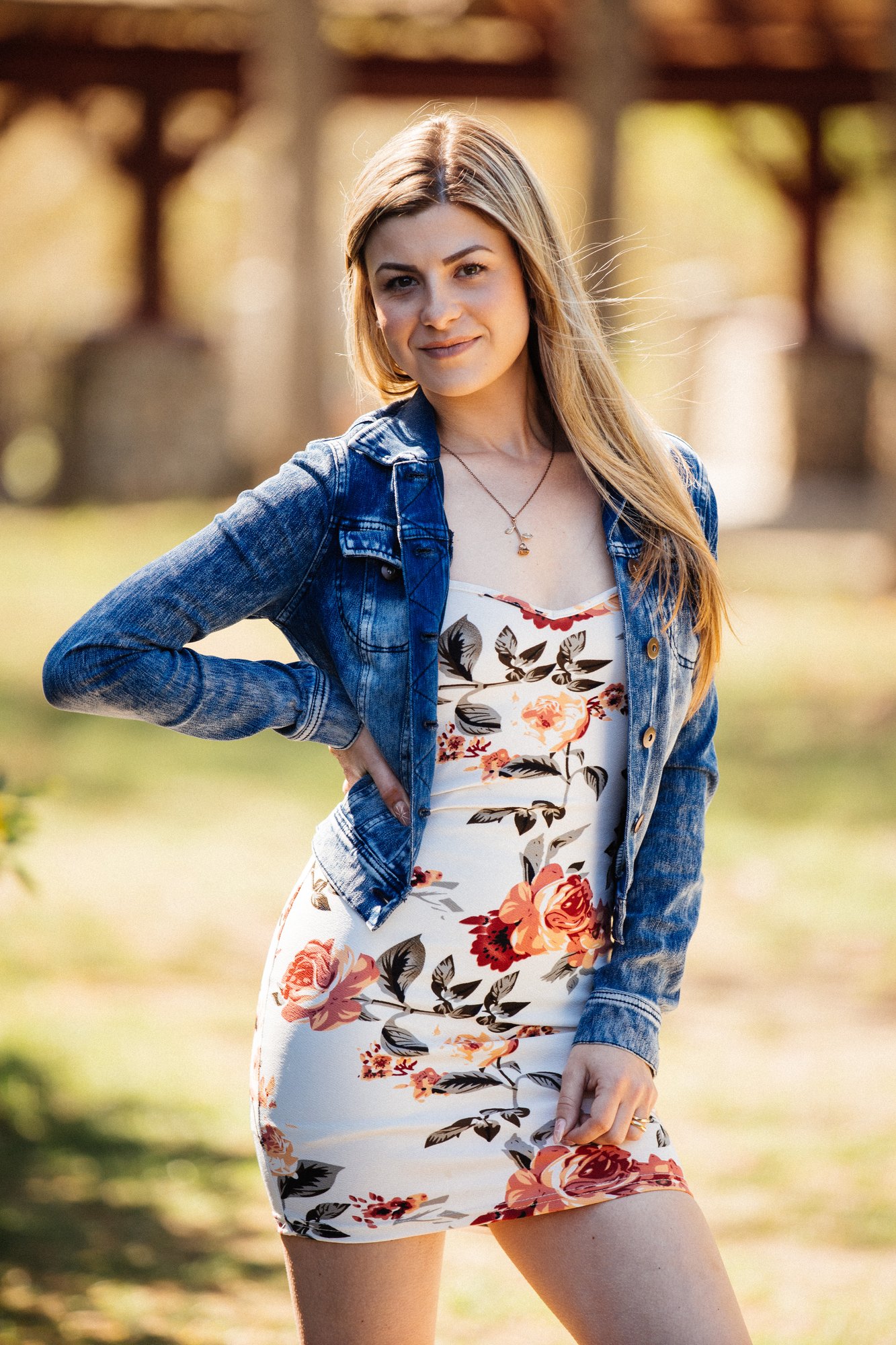Sophia — denim-jacket portrait with a hand on her hip