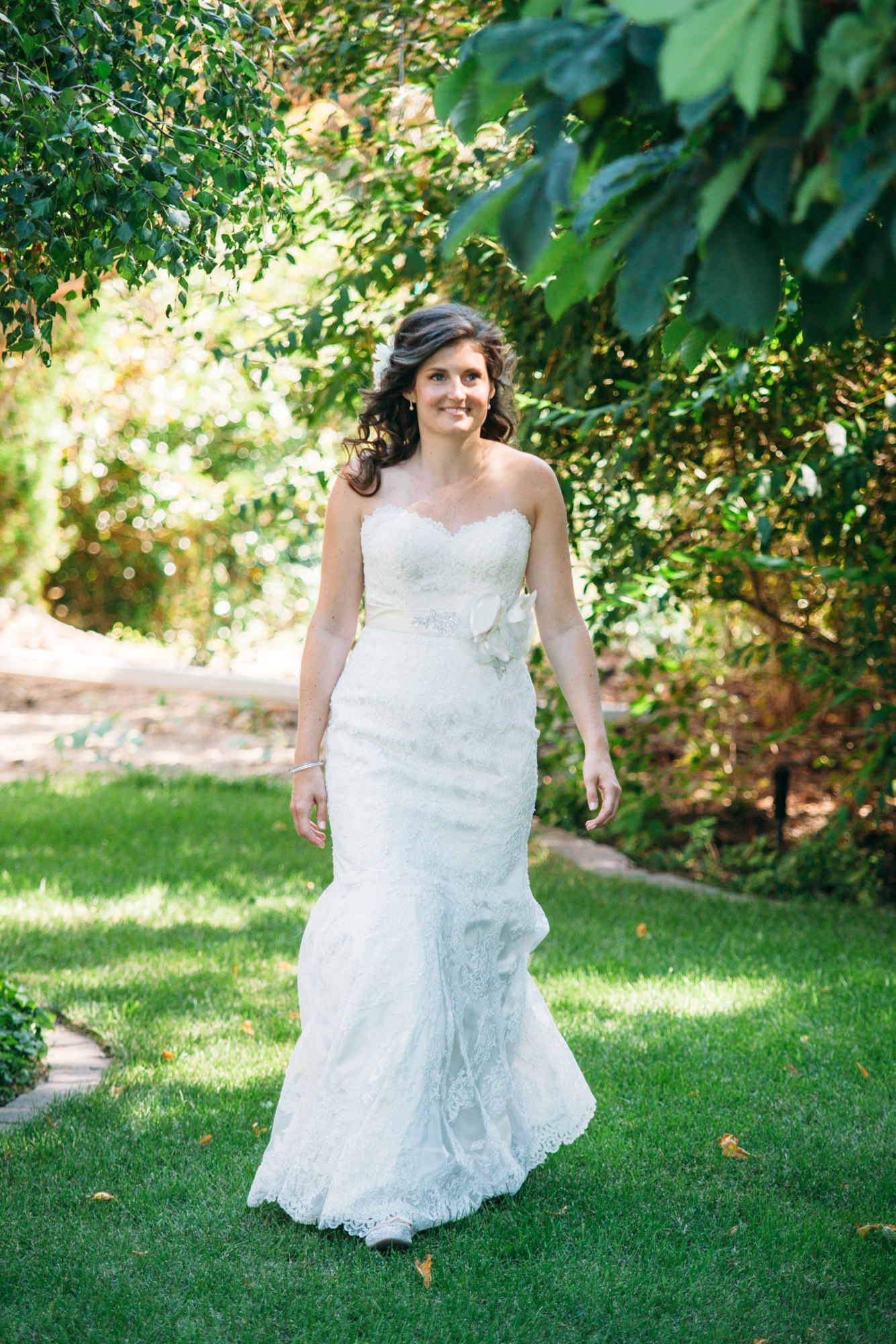 Steph & Taylor: The bride approaching through the garden.