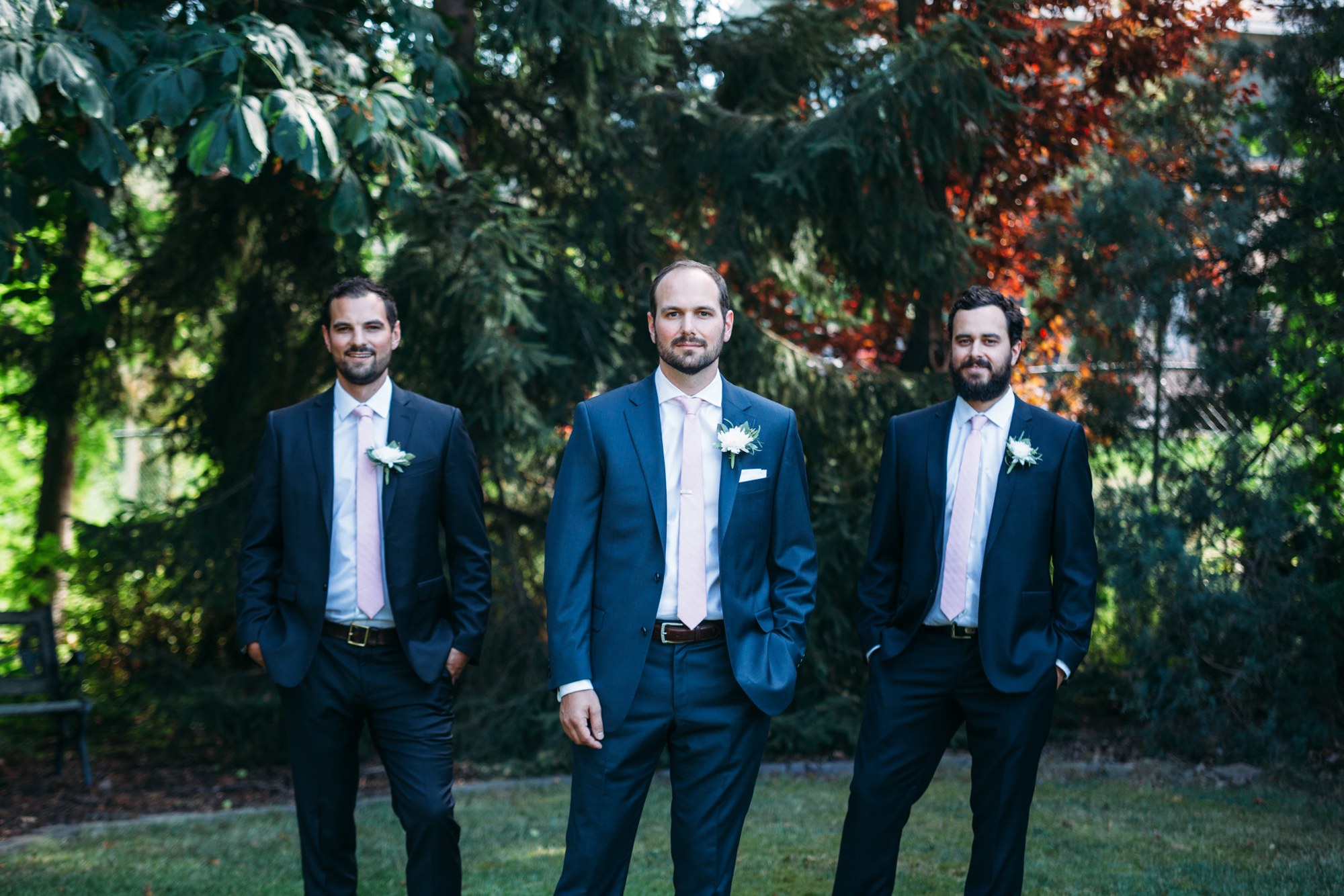 Steph & Taylor: The groom and groomsmen beneath the trees.