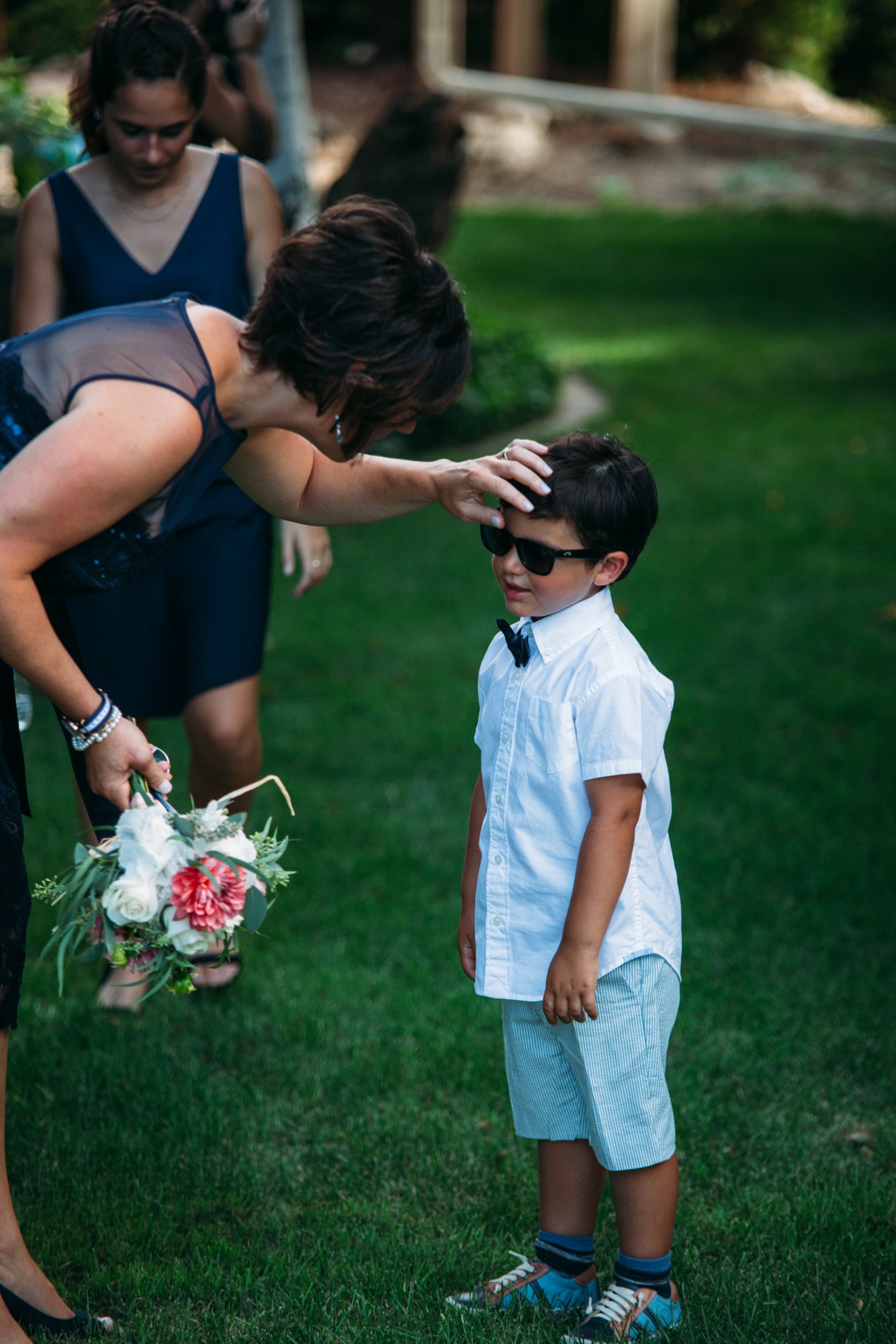 Steph & Taylor: Sunglasses being adjusted for a young guest.