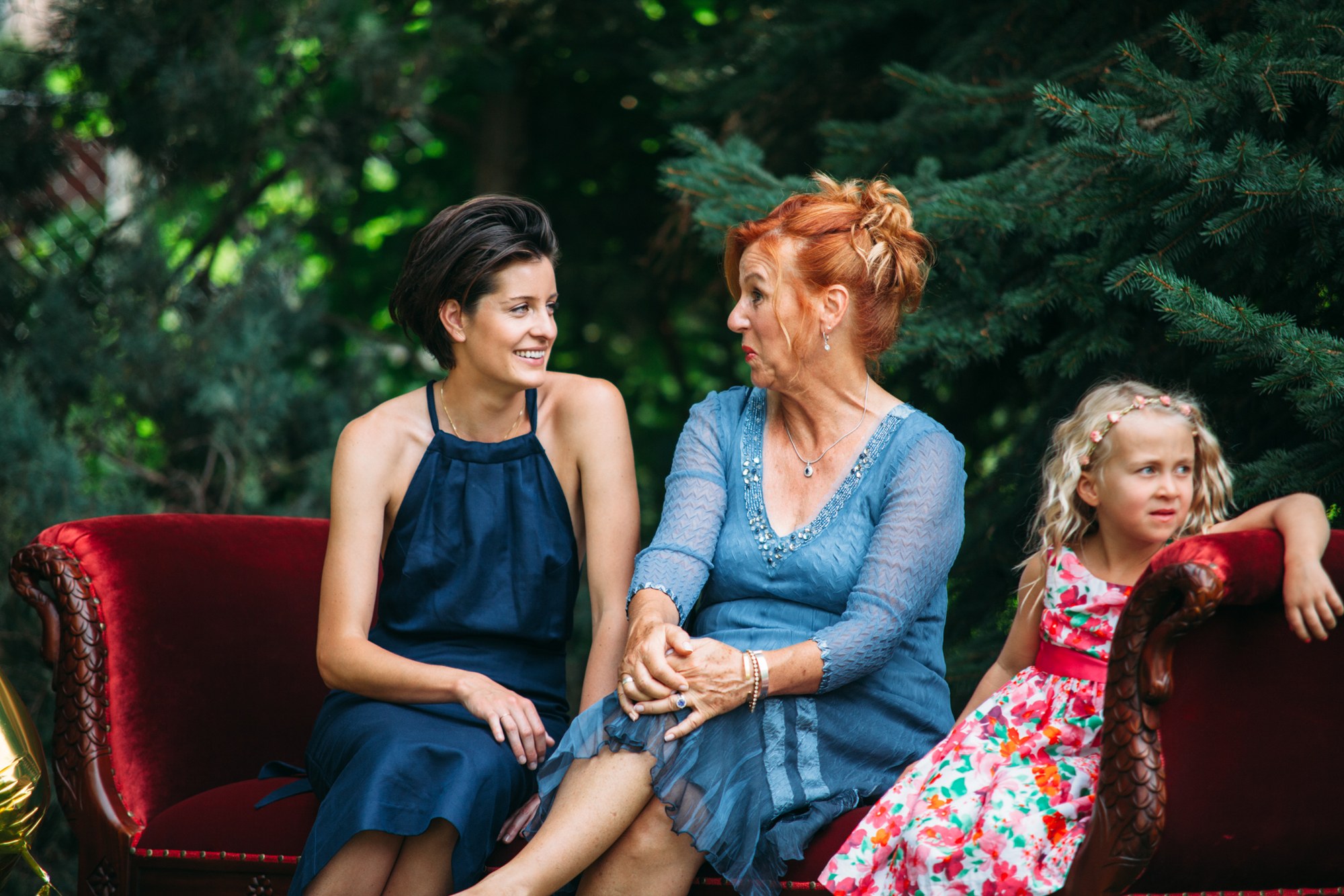 Steph & Taylor: Two guests smiling together on the garden sofa.