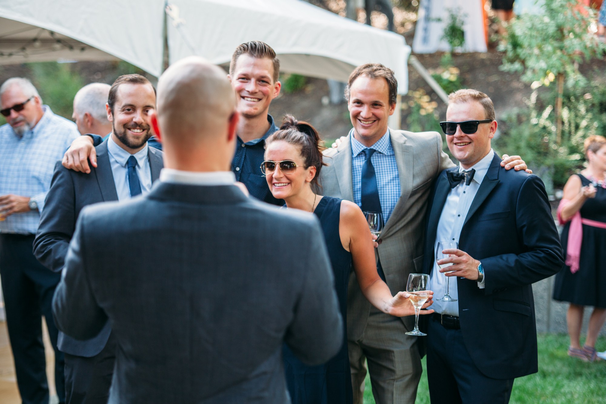 Steph & Taylor: The groom laughing among the guests.