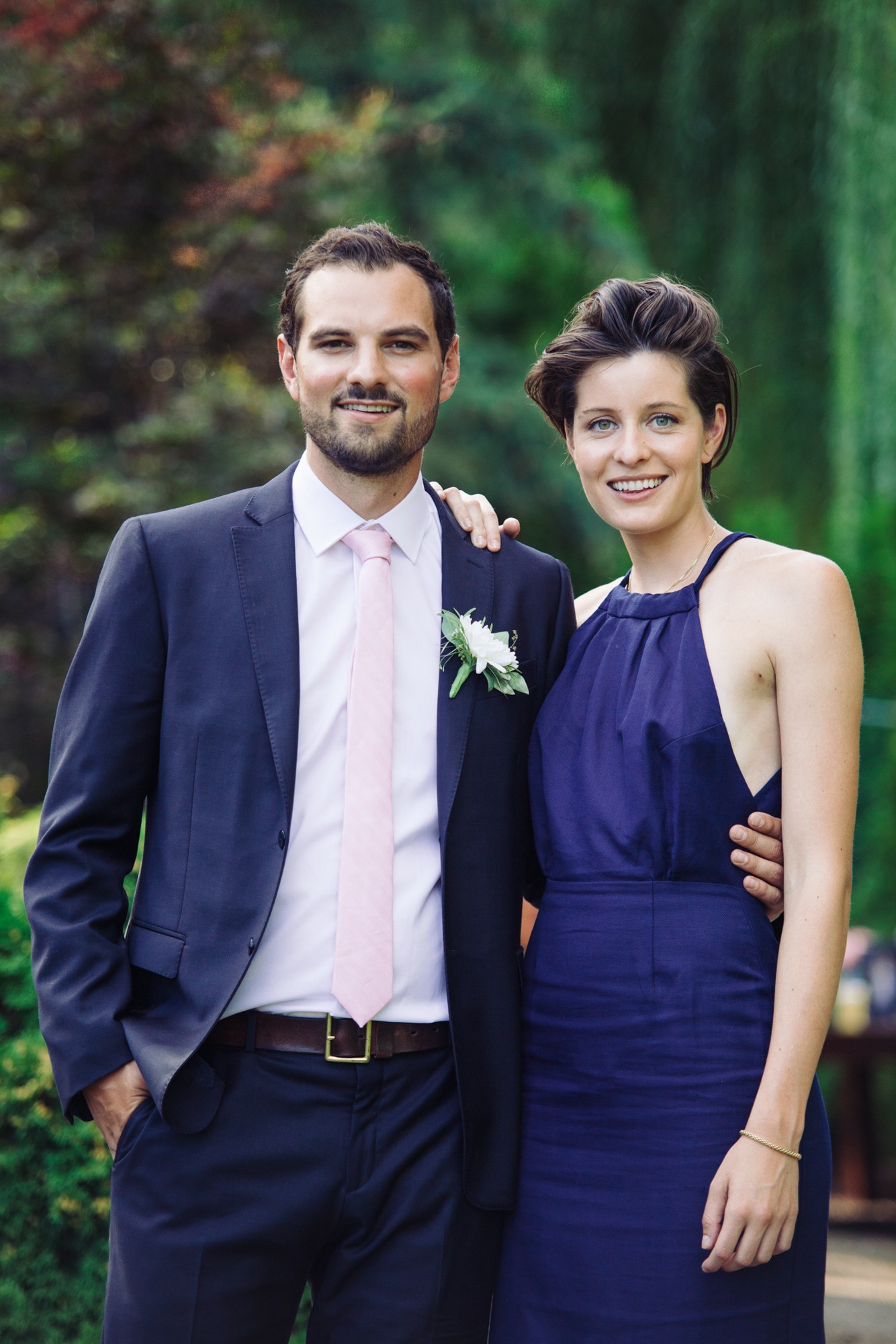 Steph & Taylor: Smiling paired guest portrait.
