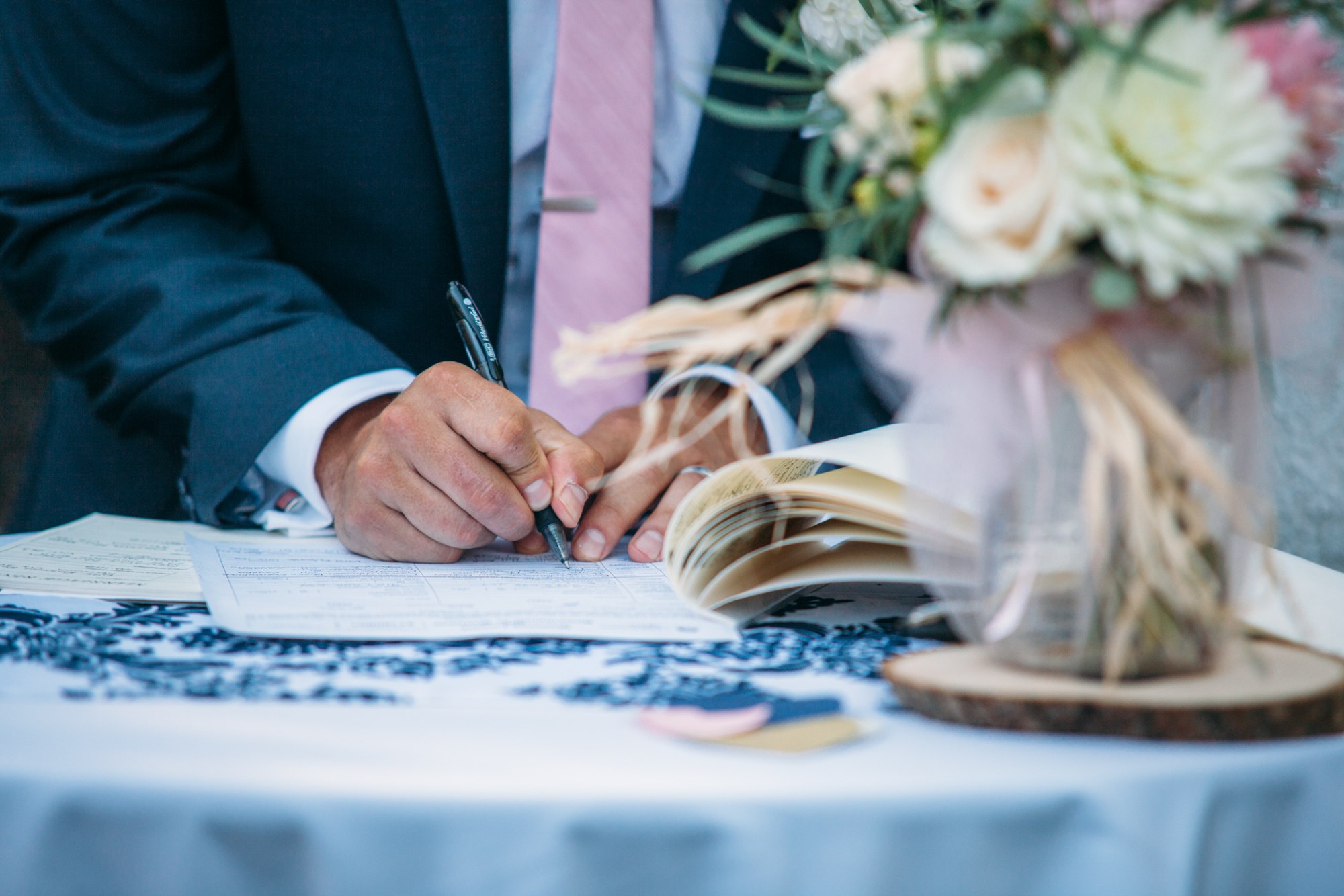 Steph & Taylor: A close view of the groom signing the register.