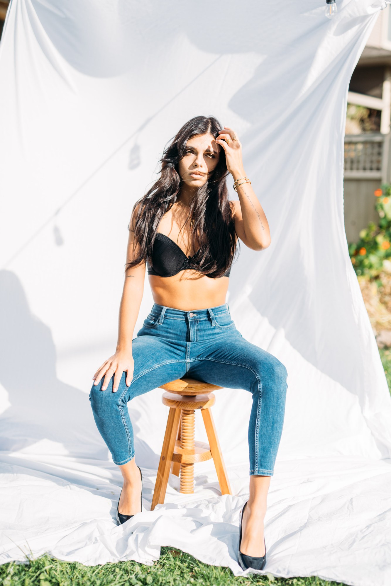 Sunny in Sunlight: Seated black lingerie and denim look.