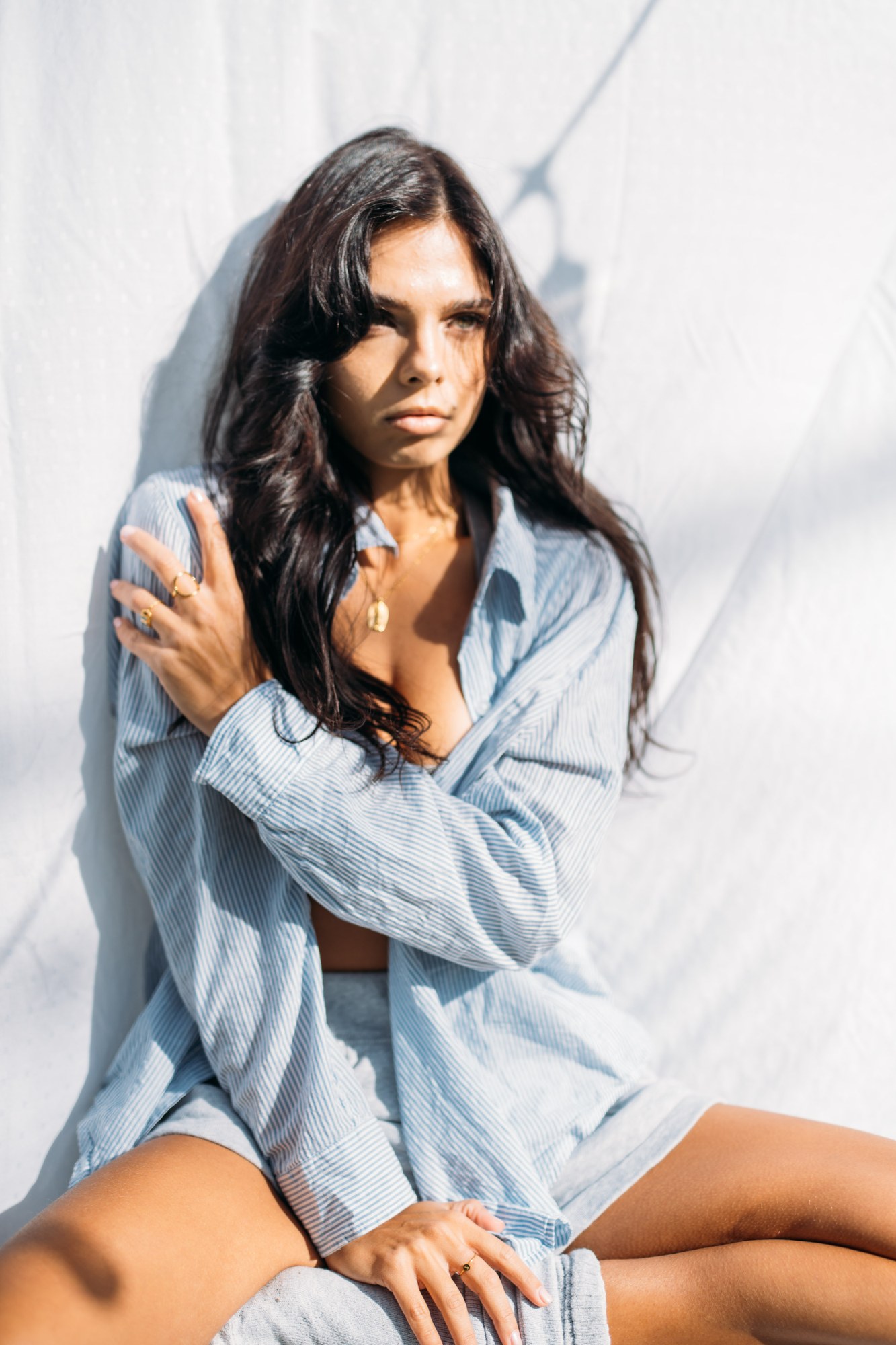 Sunny in Sunlight: Close seated portrait in the open denim shirt.