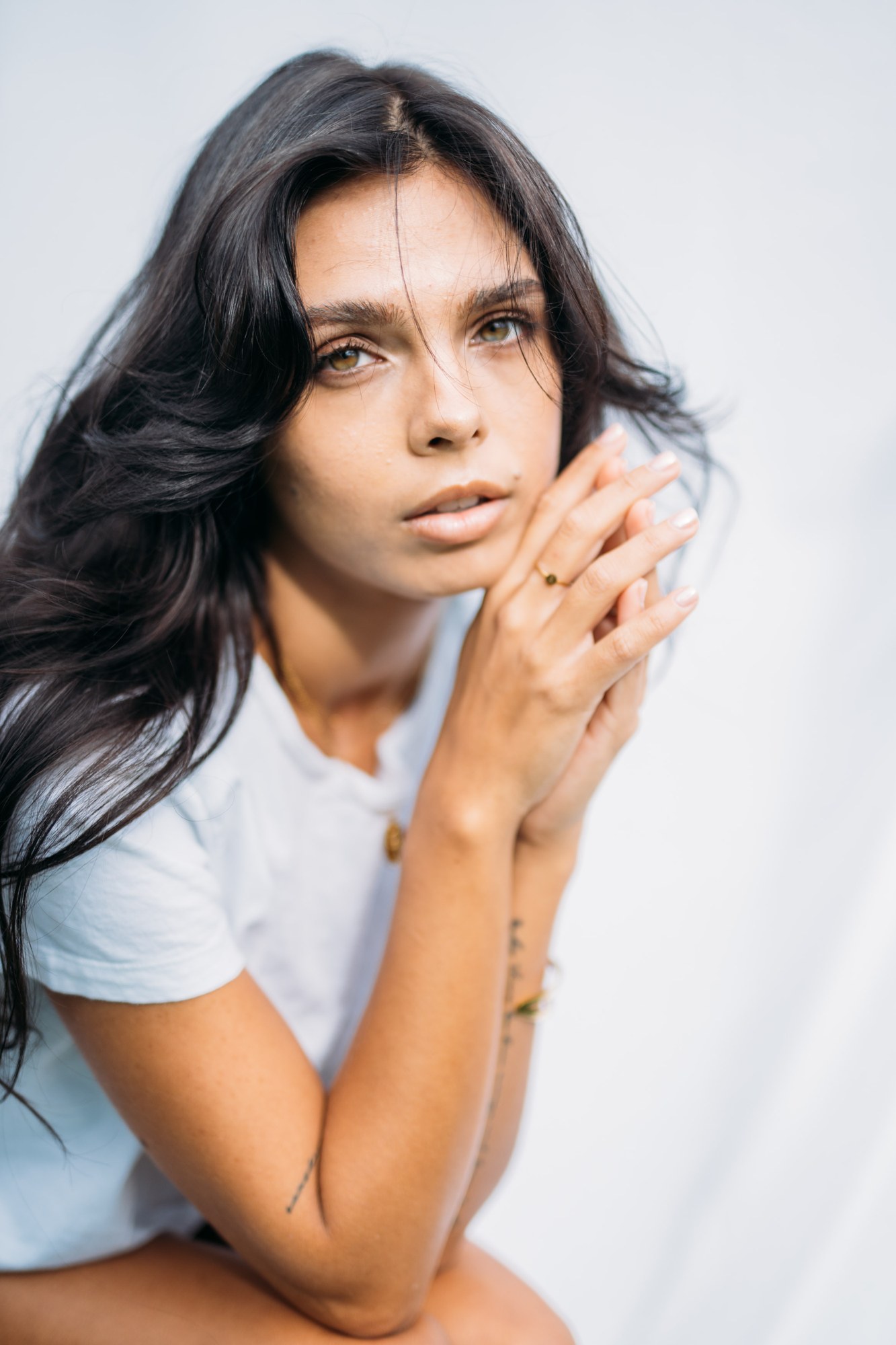 Sunny in Sunlight: Close gaze above folded hands.