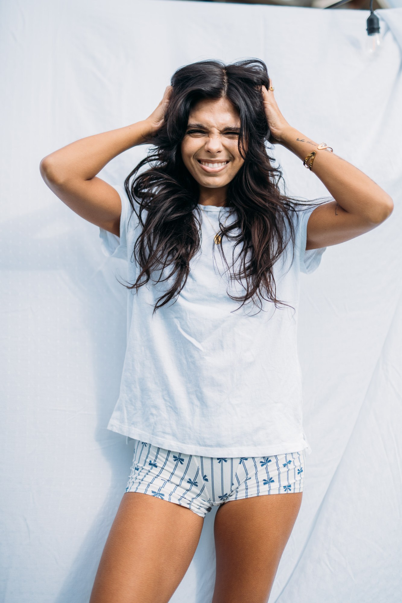 Sunny in Sunlight: Spontaneous smiling hair gesture.