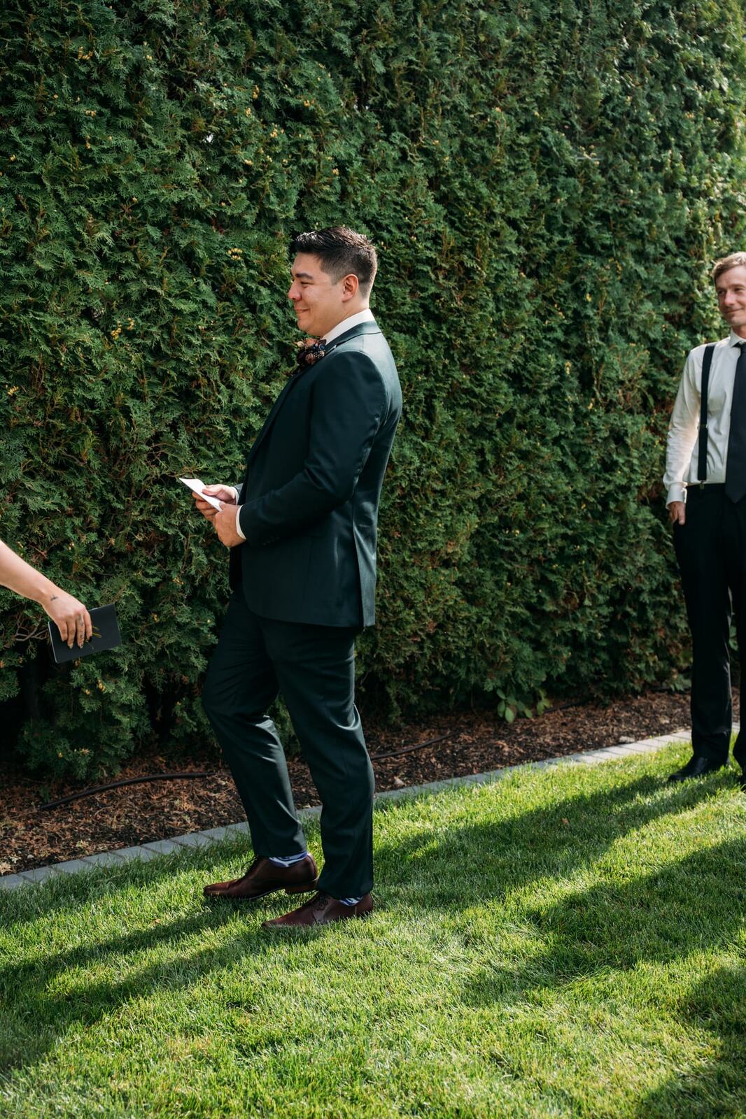 Taryn and Kai weddings story frame 7: An Okanagan vineyard wedding with ceremony, veil, guests, family, makeup by Guisachan Esthetics, and laughter woven through the altar moments..