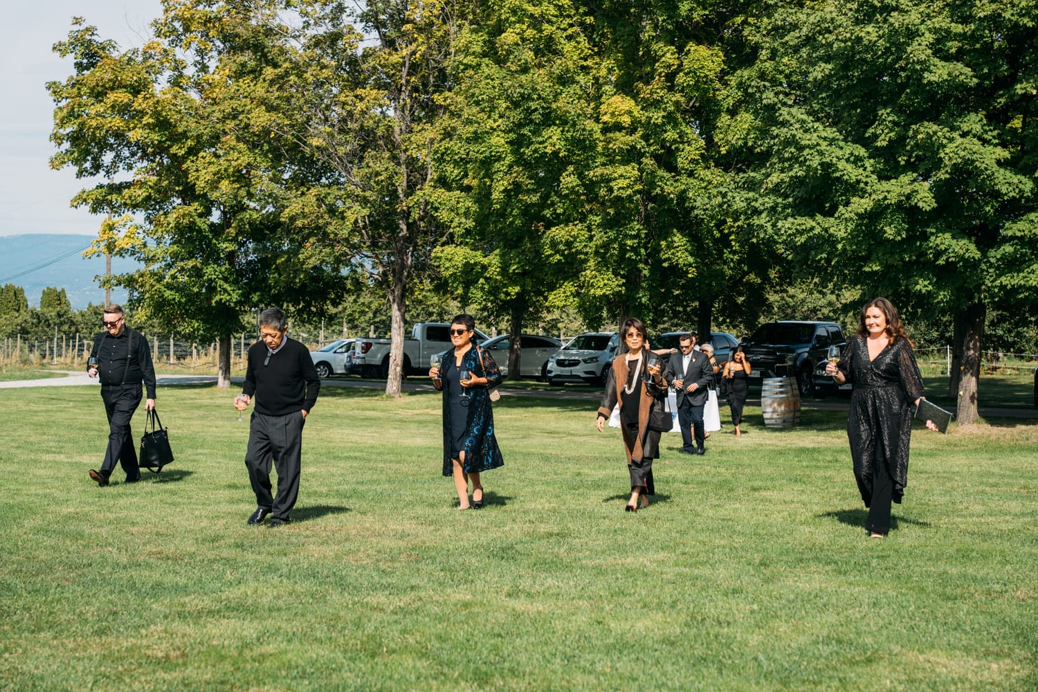 Taryn and Kai weddings story frame 10: An Okanagan vineyard wedding with ceremony, veil, guests, family, makeup by Guisachan Esthetics, and laughter woven through the altar moments..