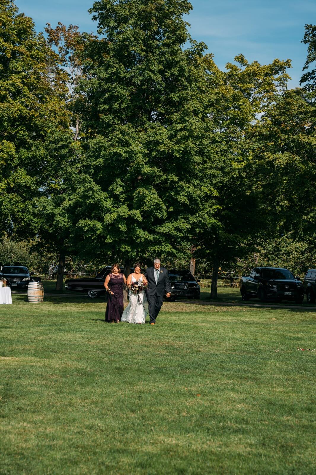 Taryn and Kai weddings story frame 17: An Okanagan vineyard wedding with ceremony, veil, guests, family, makeup by Guisachan Esthetics, and laughter woven through the altar moments..