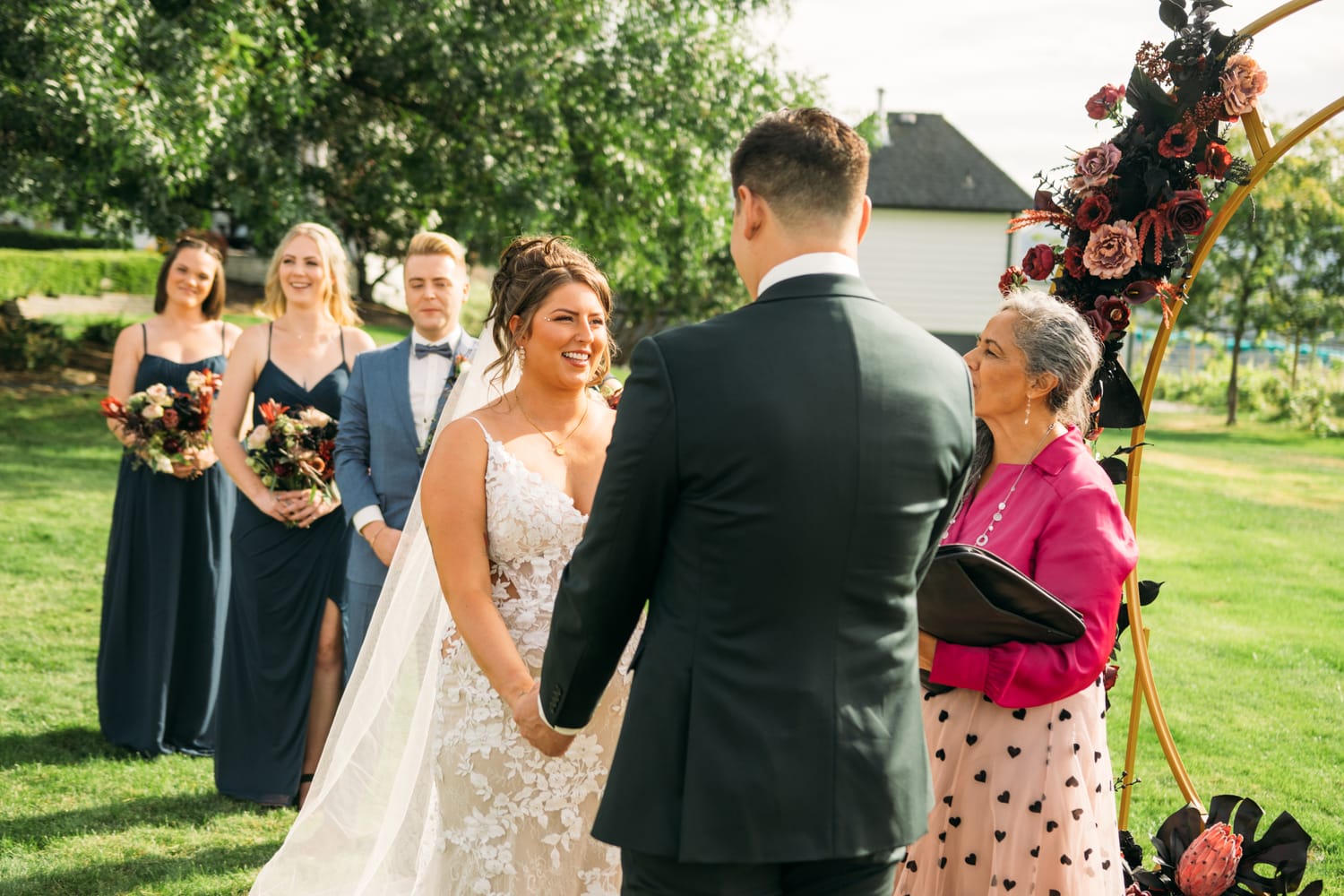 Taryn and Kai weddings story frame 18: An Okanagan vineyard wedding with ceremony, veil, guests, family, makeup by Guisachan Esthetics, and laughter woven through the altar moments..