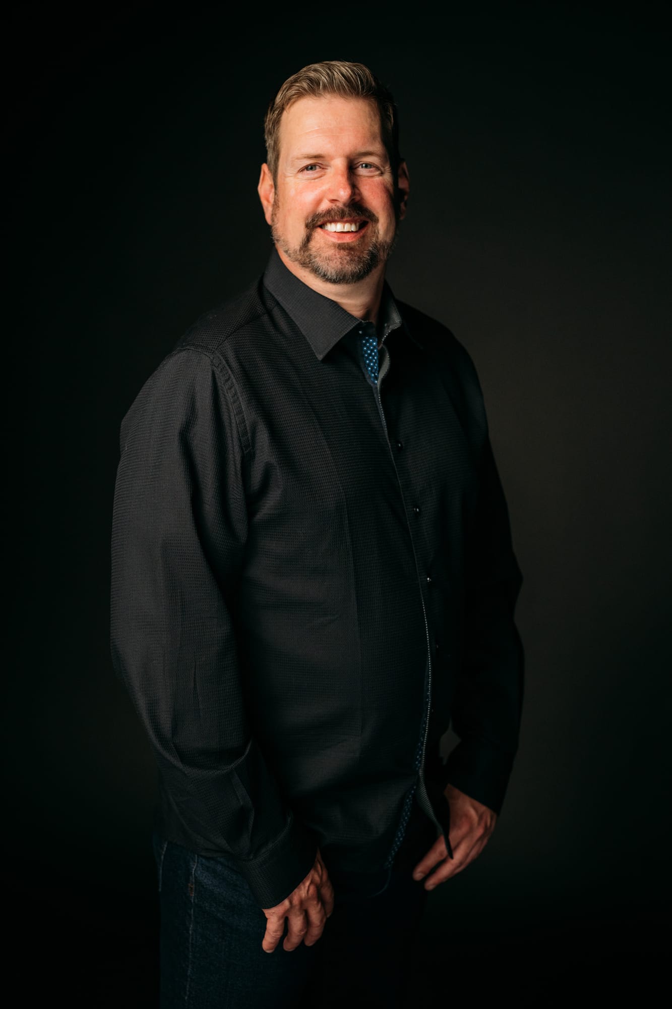 Team Bennett corporate story frame 5: Real estate team portraits at Kelowna Film Studios, with individual headshots, group photos and clean marketing images for profiles, listings and business use..