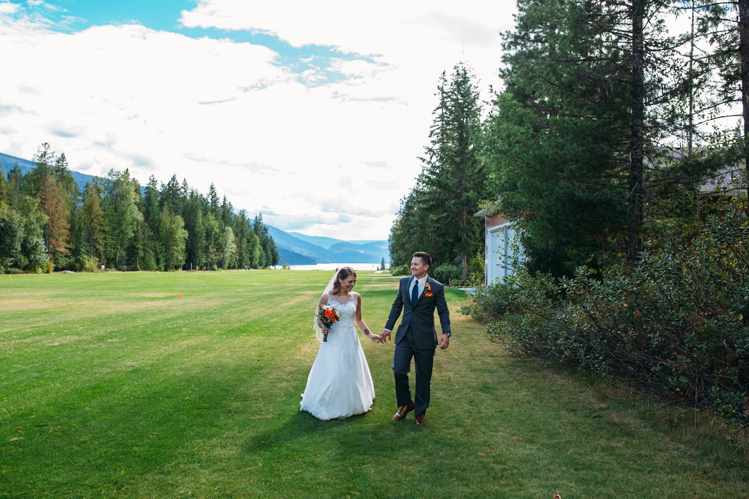 Tia and Matt weddings story frame 19: A Mabel Lake Airpark wedding in the North Okanagan, with grass-runway scenery, mountain openness and a warm end-of-night invitation..